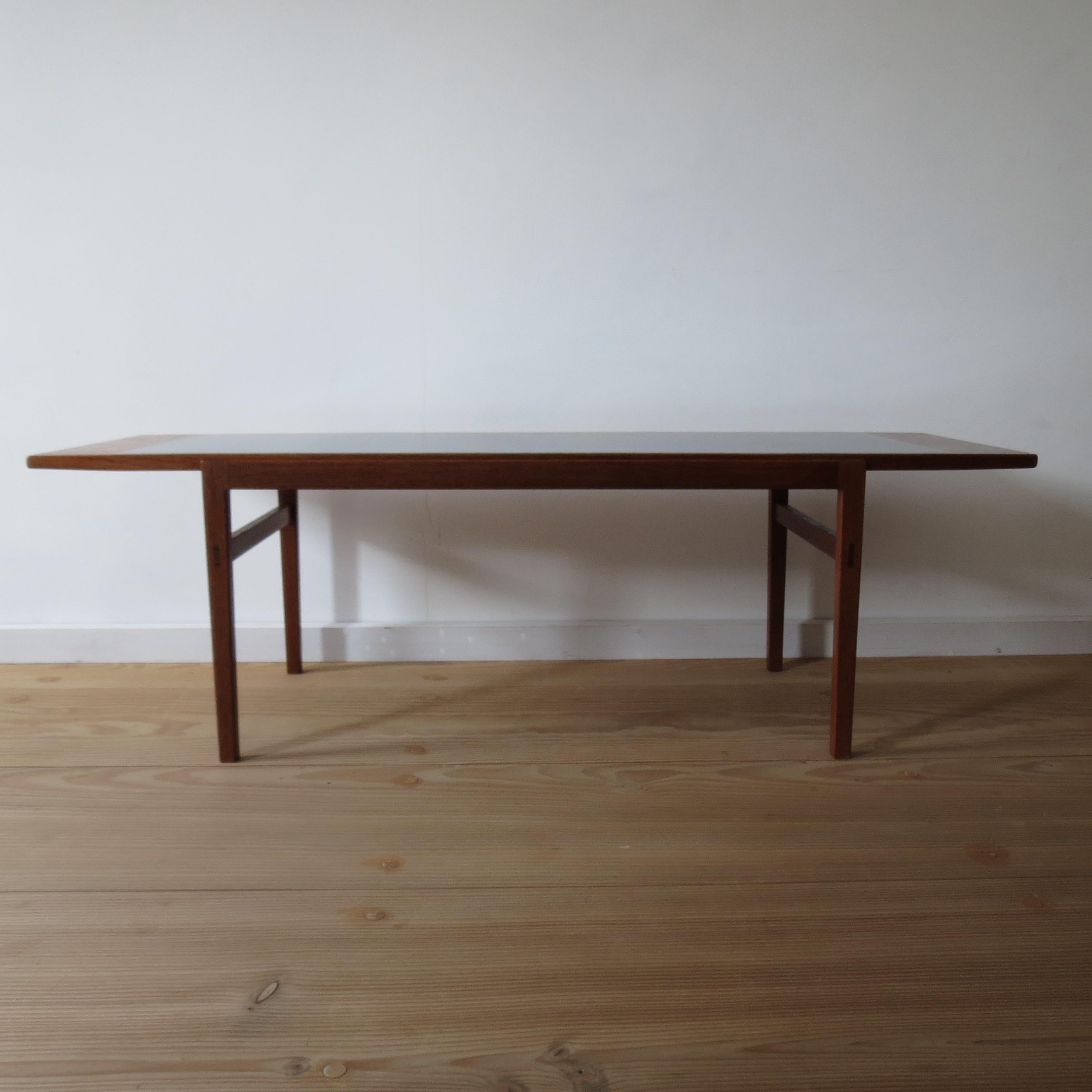 Good quality hand produced coffee table by Alan Peters. Dates from the late 1960s. Ebonized Teak top and solid Teak legs. Very nice tenon detail to the tops of the legs, through tenons with Ebony wedges, often seen on Alan Peter's pieces. Oregon