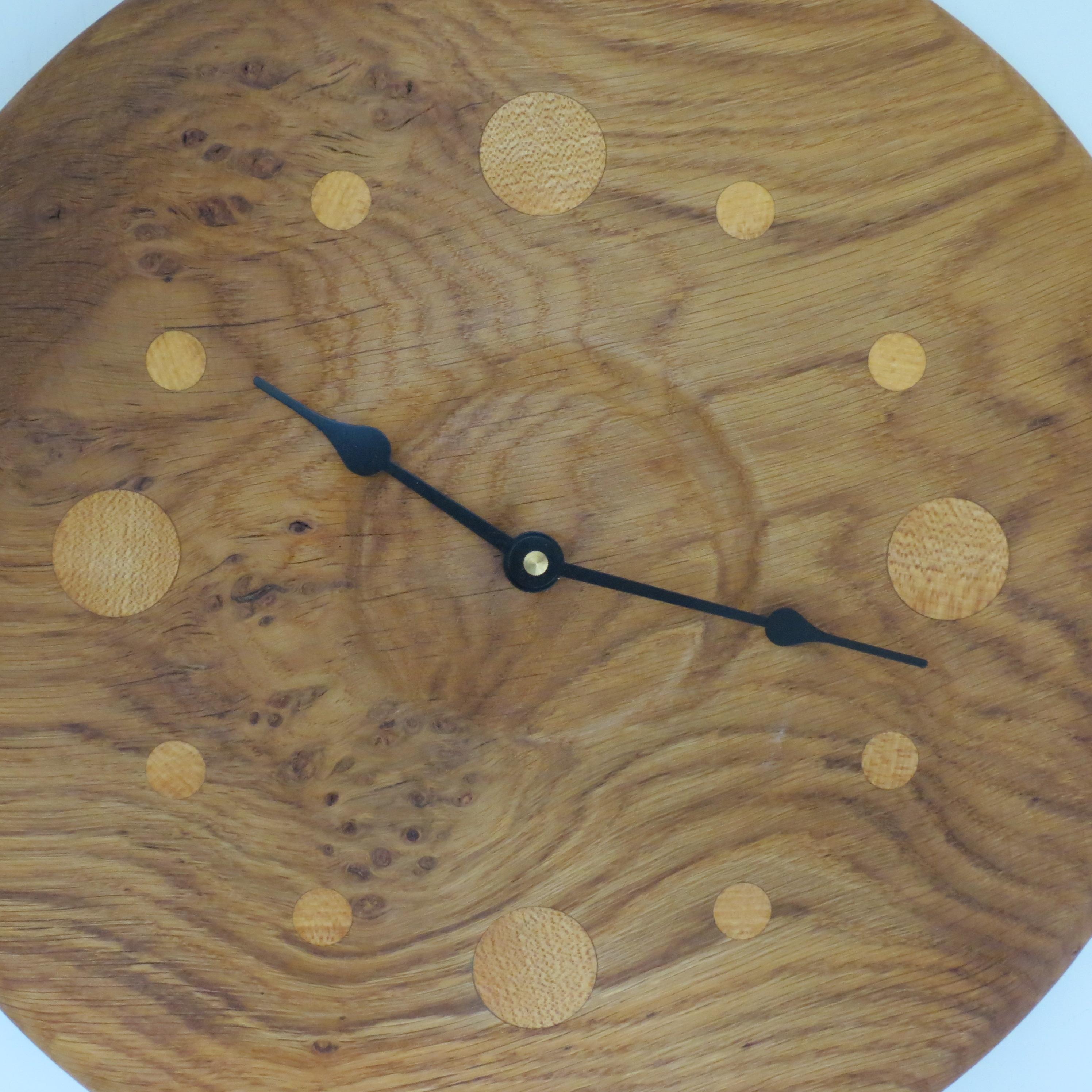 Hand produced wooden wall clock, made from oak with detail in Sycamore wood. Very good quality, well made stylish clock similar in style to George Nelson. 

In good working order. 

Stamped to the rear Kilmary Workshop, Isle of Arron.