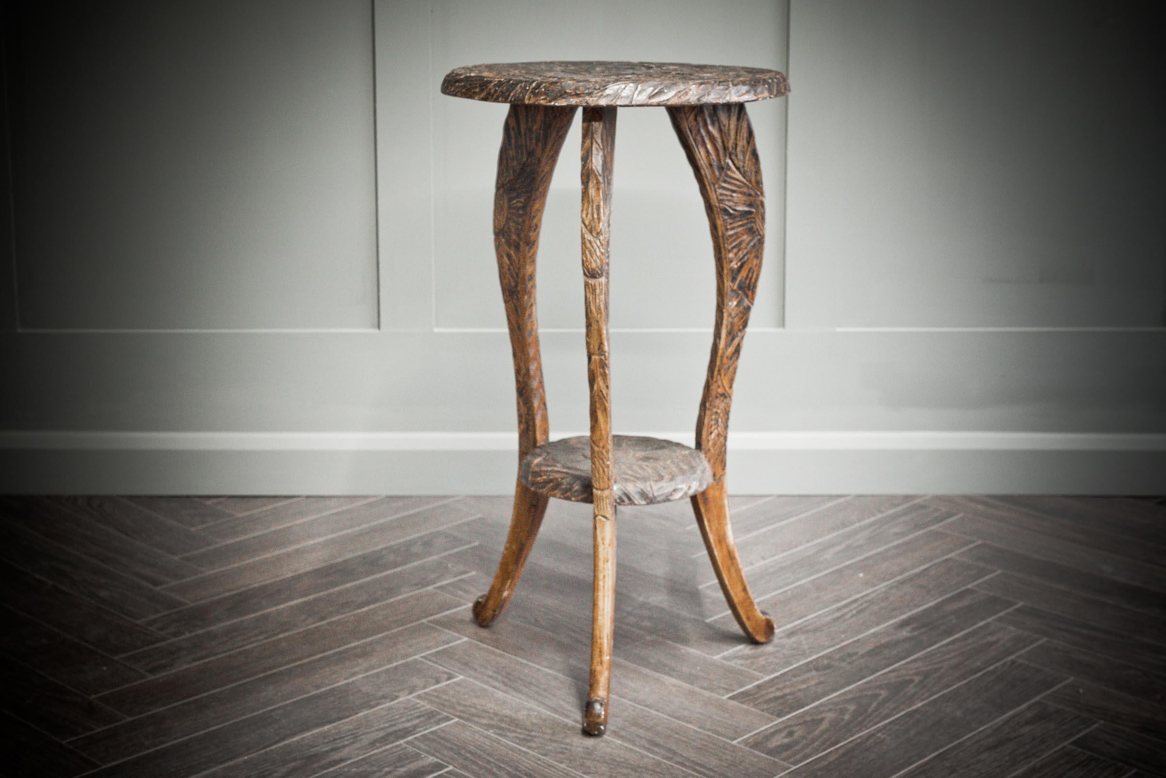 Beautiful hand carved side table presented in Libertys of London with its intricate floral pattern hand scraped into the wood to create a striking piece for any home. The table is made from mahogany throughout with three legs all holding the same