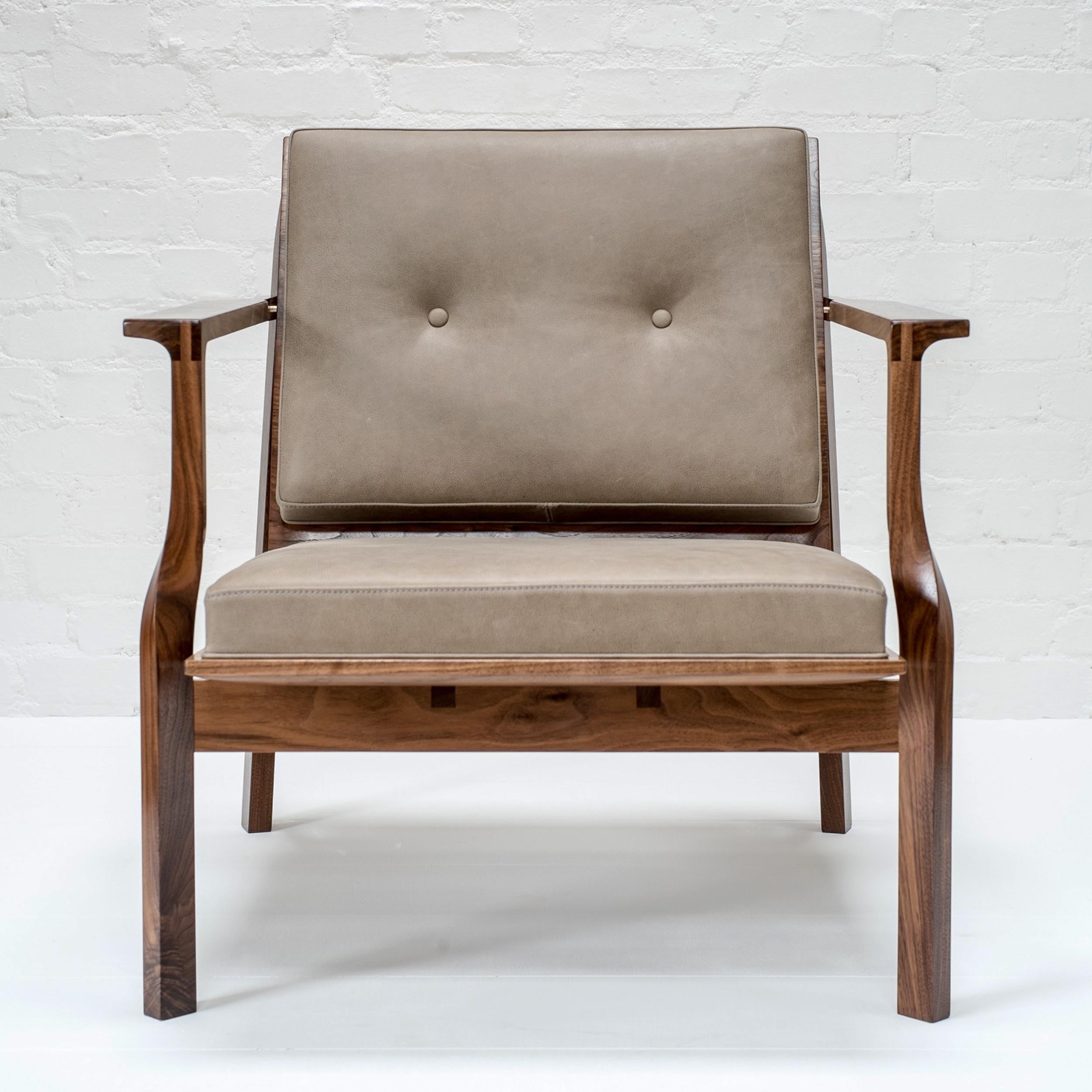 Hand sculpted American black walnut chair frame and seat with ash leather upholstery. Wooden and brass dowel detail.

Hand finished with natural oils and wax.

Upholstry, full seat (see suilven lounge chair) or seperate seat and back in a