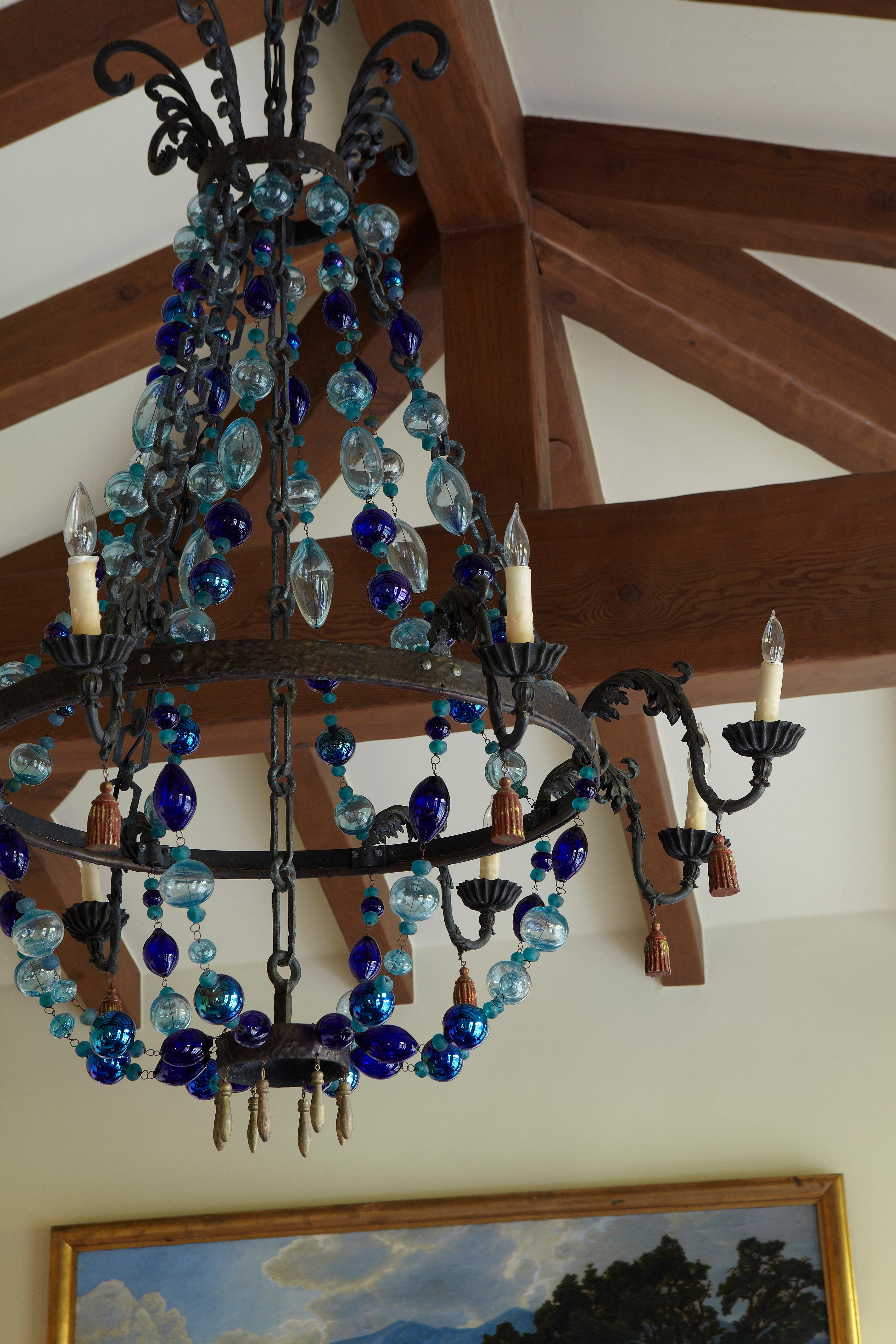 A hand-sculpted and forged Bronze  chandelier with hand-blown glass, or with antiqued gessoed beads. Each piece is numbered and signed.. Custom sizes and finishes available.
