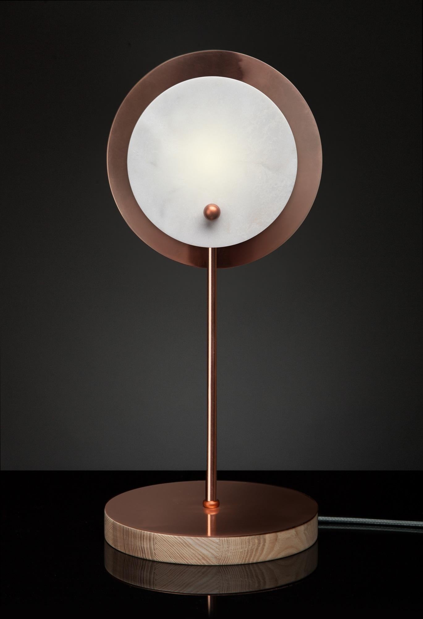 Hand-sculpted onyx table lamp, Stoned Sun
Materials: Copper sprayed polished stainless steel, onyx, ash 
Dimensions: 45 x 20 x 20 cm
Light: G9 LED bulb


SKELD Design is a contemporary design studio. 
We focus on interior lighting and