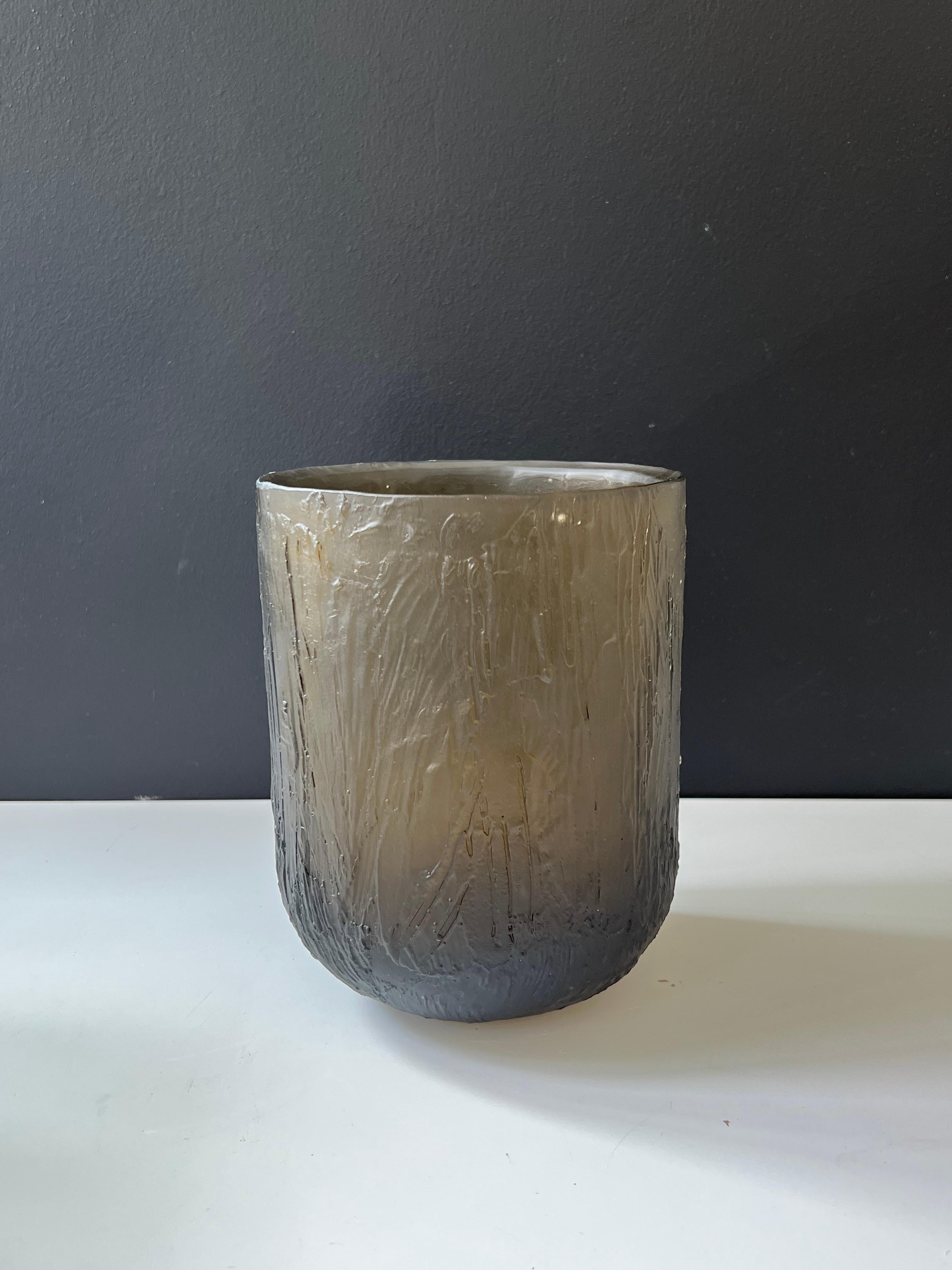 A unique cast glass vase in olive color. With intricate hand-sculpted details on its surface, resembling the trunk of a tree , the vase is sculptural as well as functional. With 20 cm / 7.7'' height, it works well with many types of flowers whether
