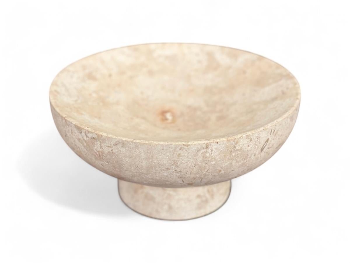 This hand sculpted vase, crafted from Mayan Travertine in a cream color, is an exquisite piece produced by Taller Maya. Its elegant, minimalist design features a perfectly rounded bowl supported by a sturdy, tapered base, making it a versatile