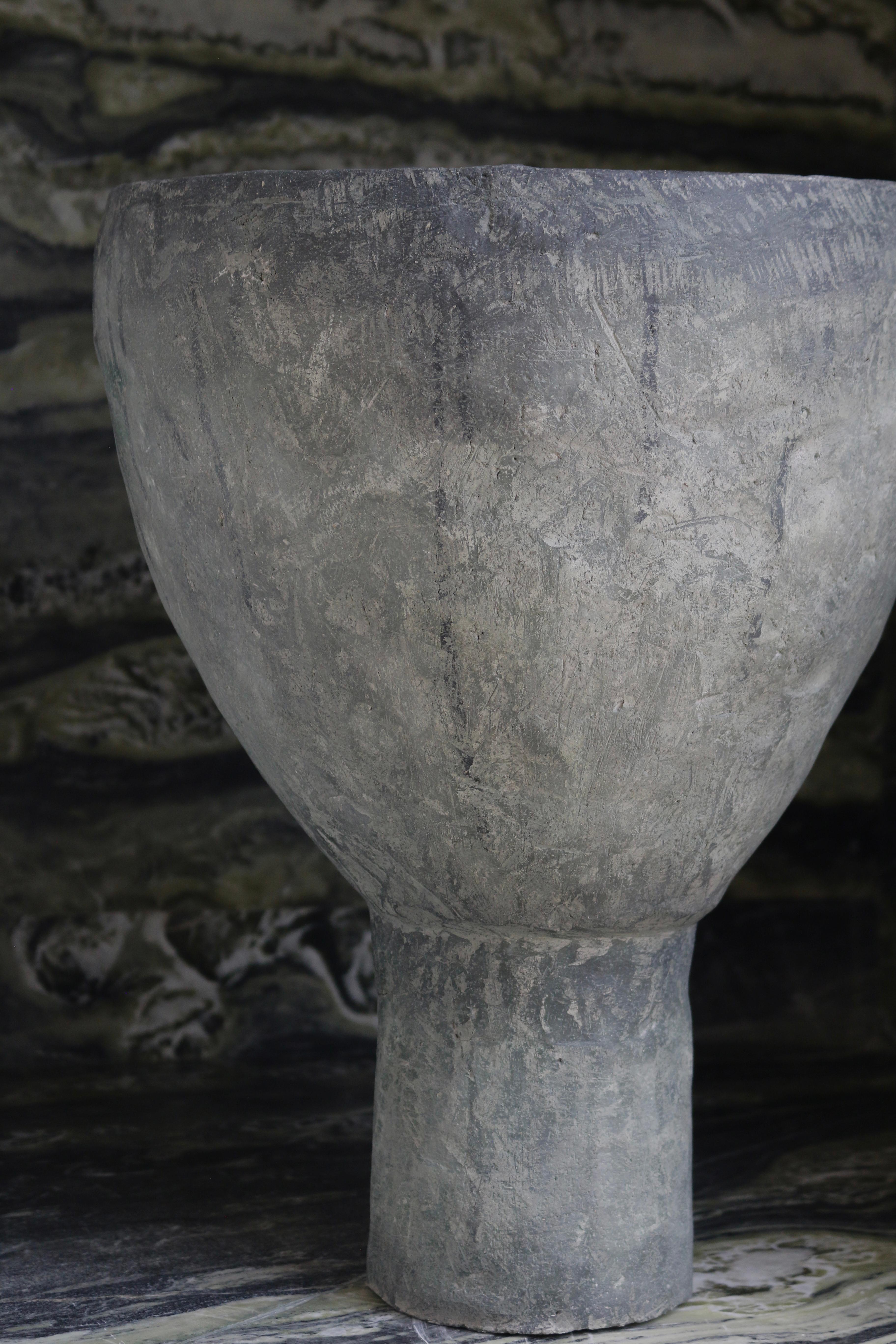 Crafted in cement and clay, the Vase Collection evokes the quiet strength of ancient vessels with a distinctly contemporary spirit. Each piece is sculpted to celebrate organic imperfection — no two are alike. The surface is layered with earthy