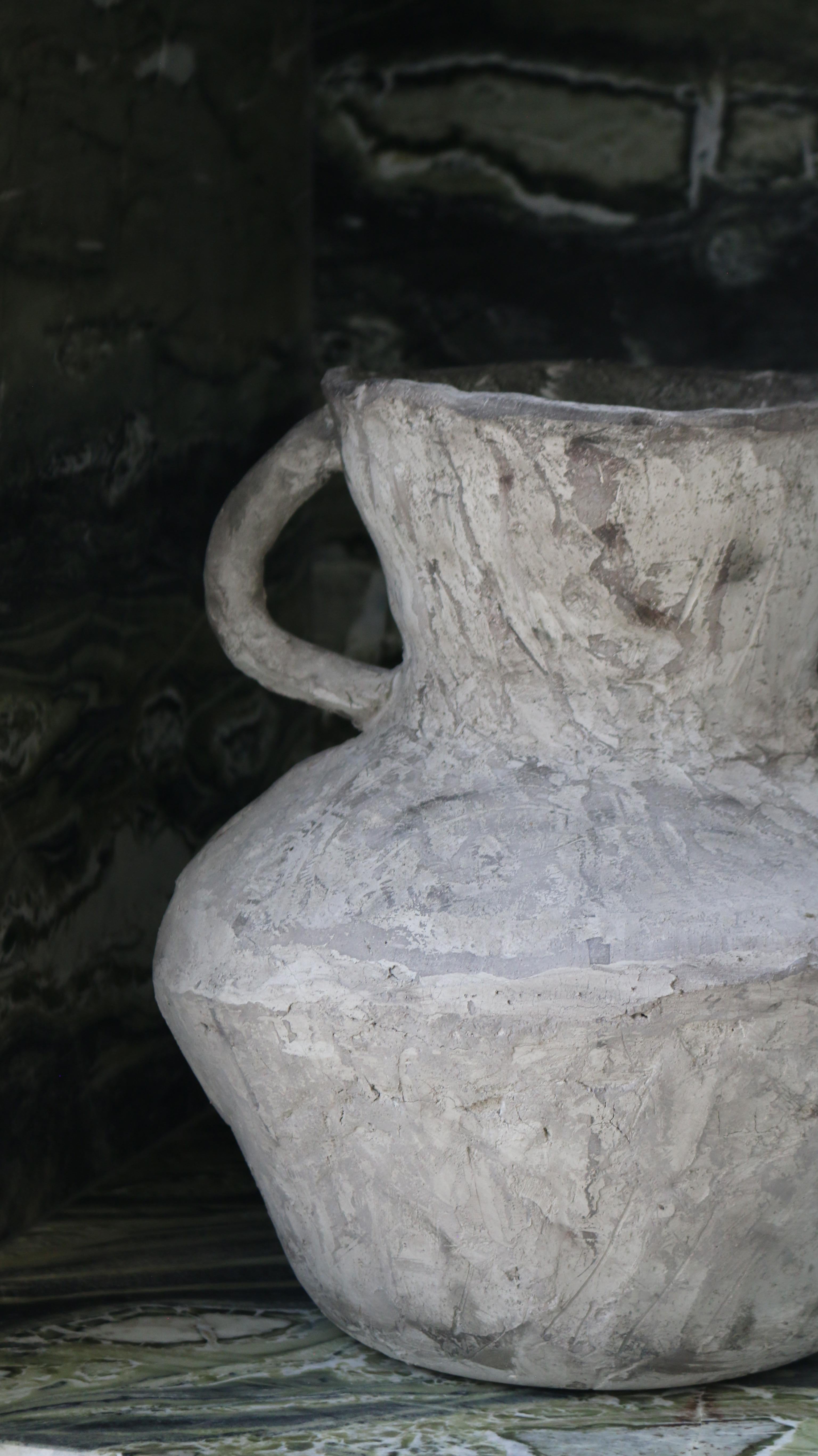 Crafted in cement and clay, the Vase Collection evokes the quiet strength of ancient vessels with a distinctly contemporary spirit. Each piece is sculpted to celebrate organic imperfection — no two are alike. The surface is layered with earthy