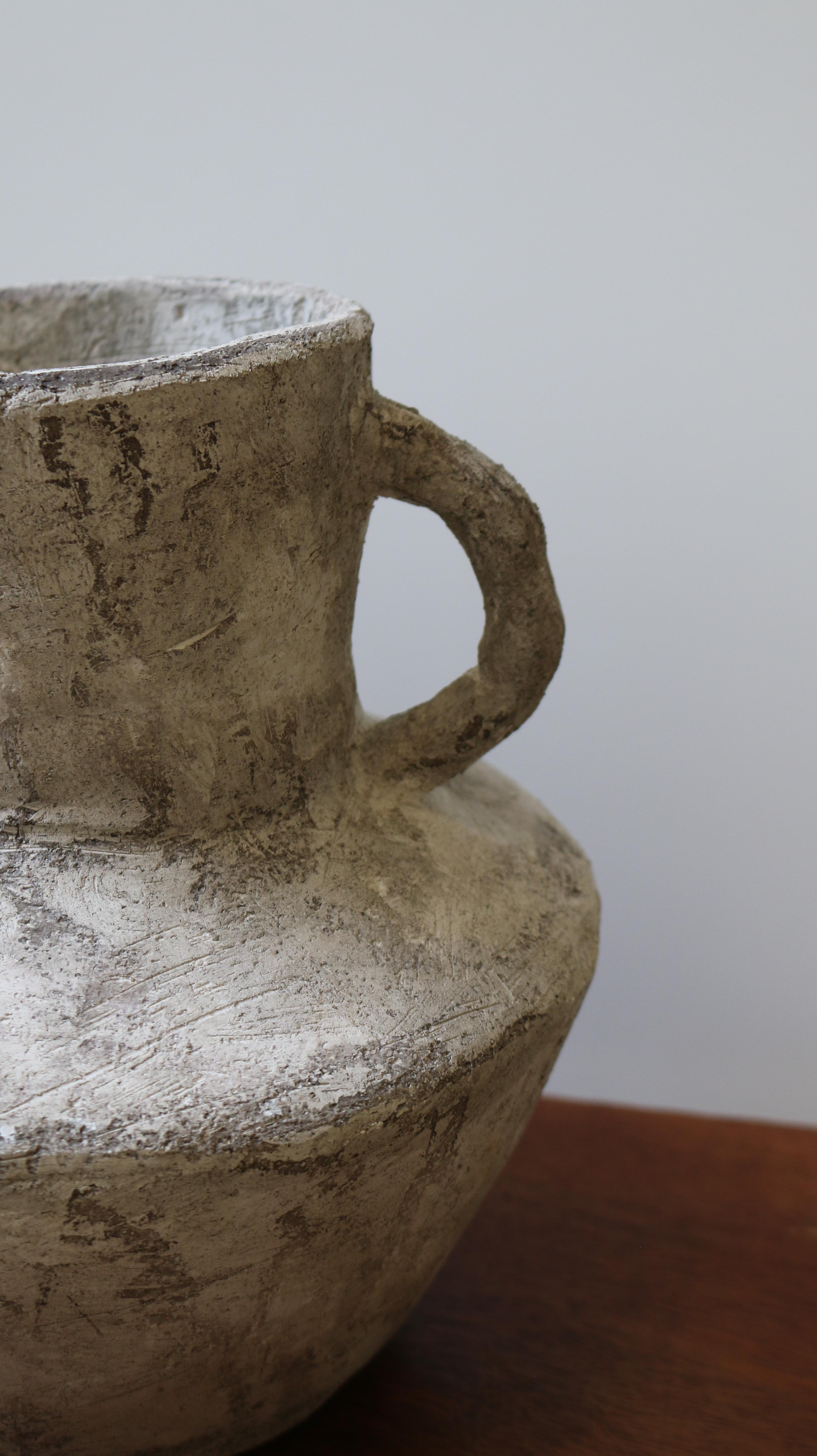 Crafted in cement and clay, the Vase Collection evokes the quiet strength of ancient vessels with a distinctly contemporary spirit. Each piece is sculpted to celebrate organic imperfection — no two are alike. The surface is layered with earthy