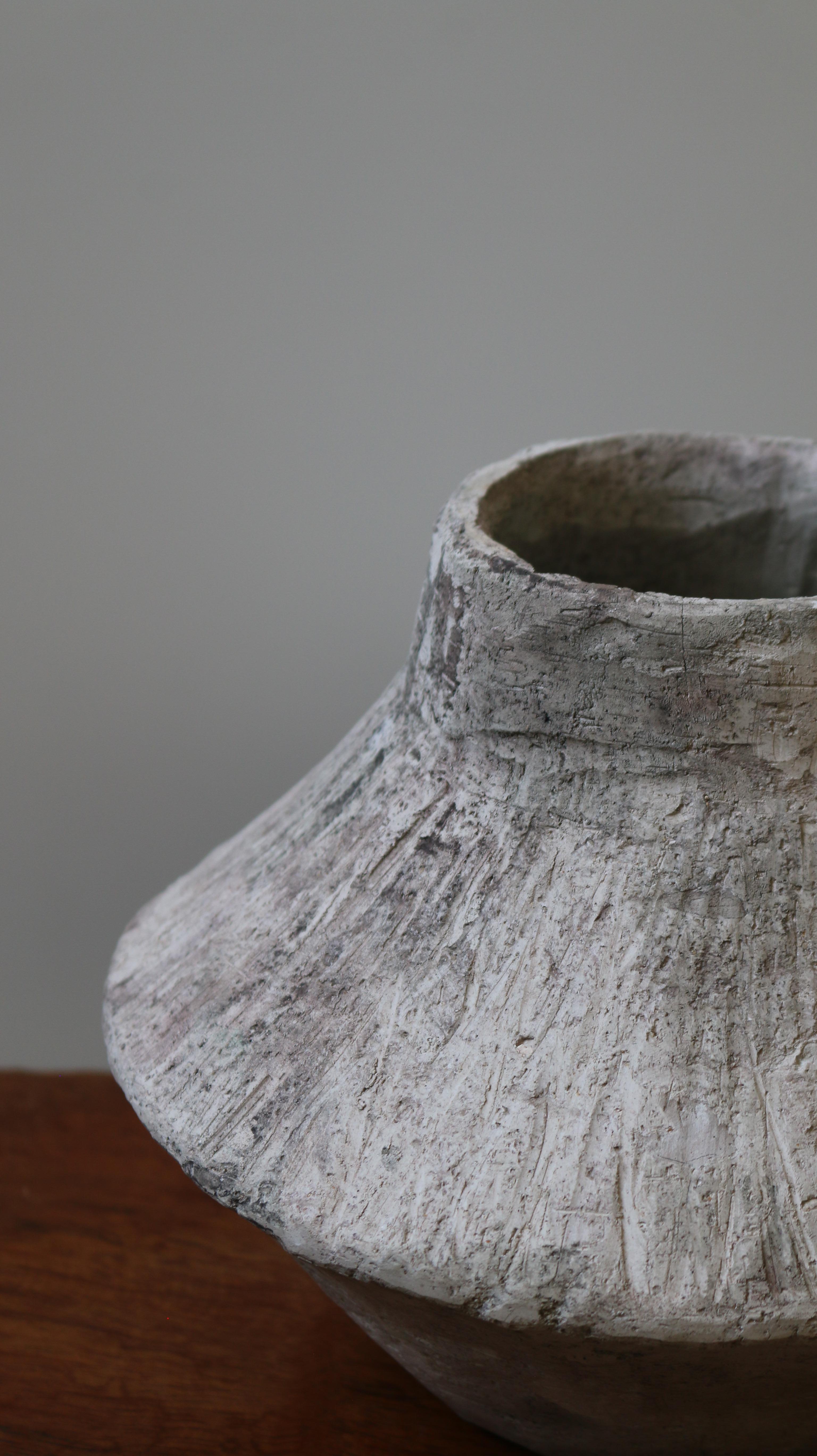 Crafted in cement and clay, the Vase Collection evokes the quiet strength of ancient vessels with a distinctly contemporary spirit. Each piece is sculpted to celebrate organic imperfection — no two are alike. The surface is layered with earthy