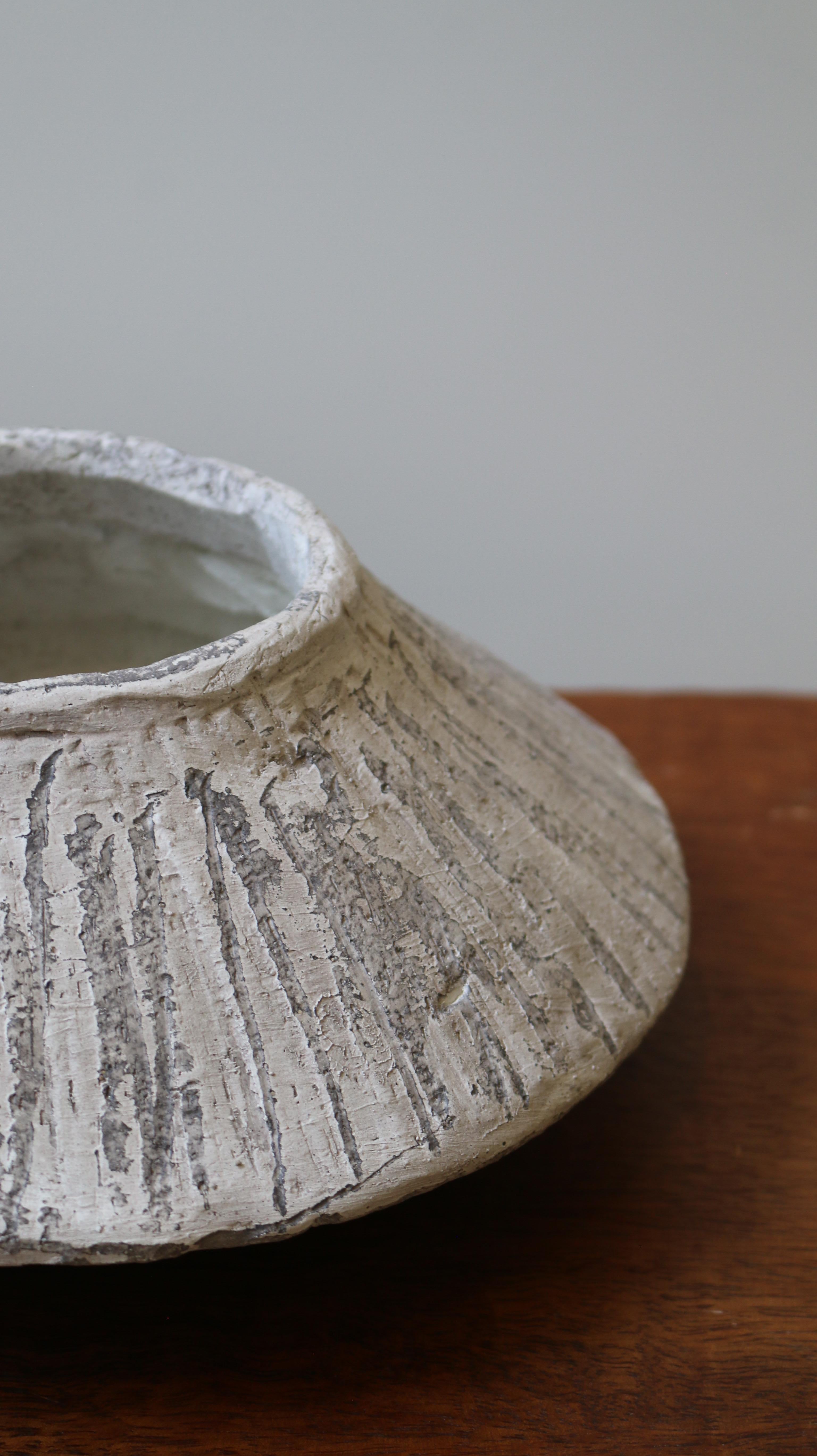 Crafted in cement and clay, the Vase Collection evokes the quiet strength of ancient vessels with a distinctly contemporary spirit. Each piece is sculpted to celebrate organic imperfection — no two are alike. The surface is layered with earthy
