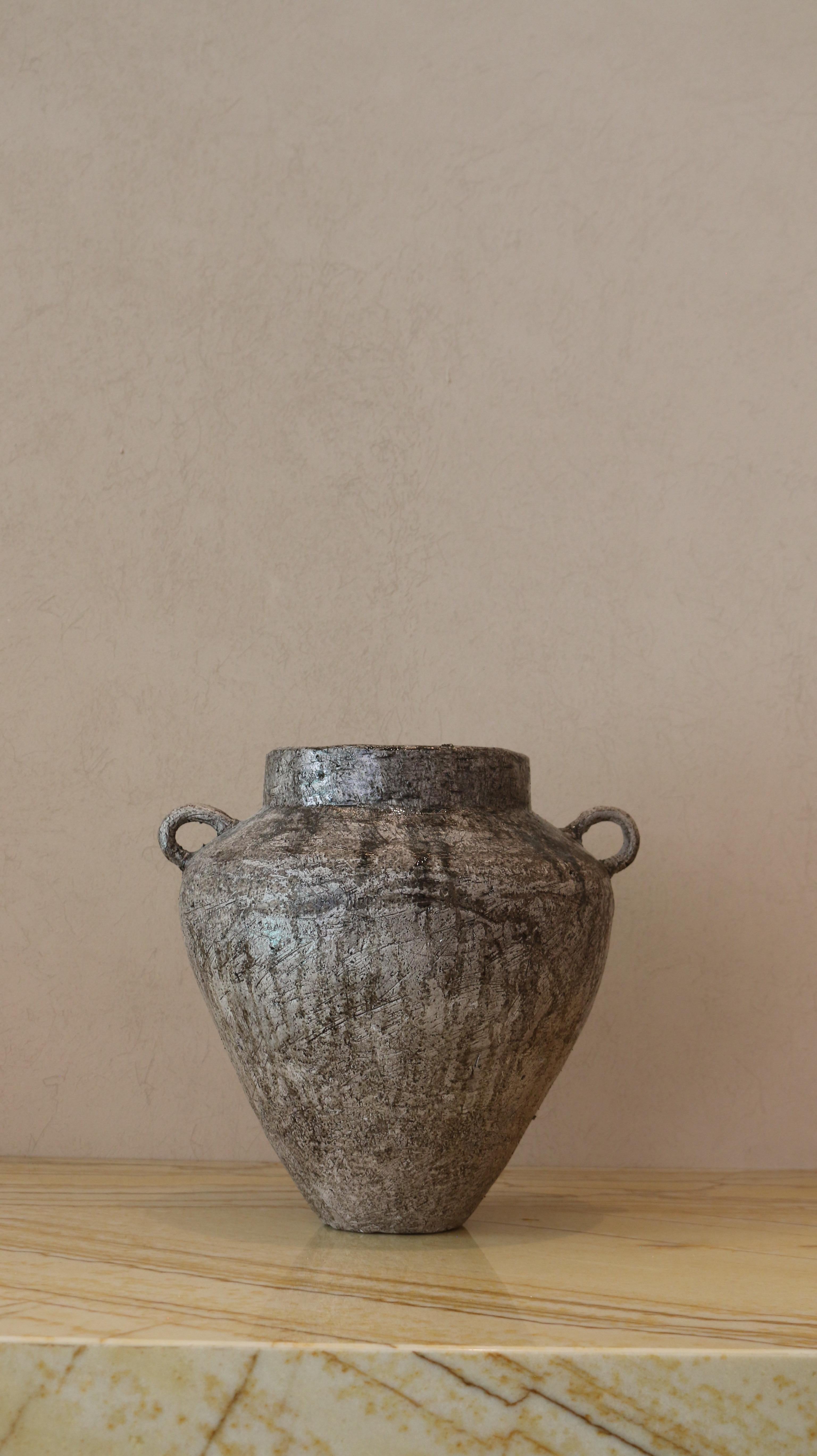 Crafted in cement and clay, the Vase Collection evokes the quiet strength of ancient vessels with a distinctly contemporary spirit. Each piece is sculpted to celebrate organic imperfection — no two are alike. The surface is layered with earthy