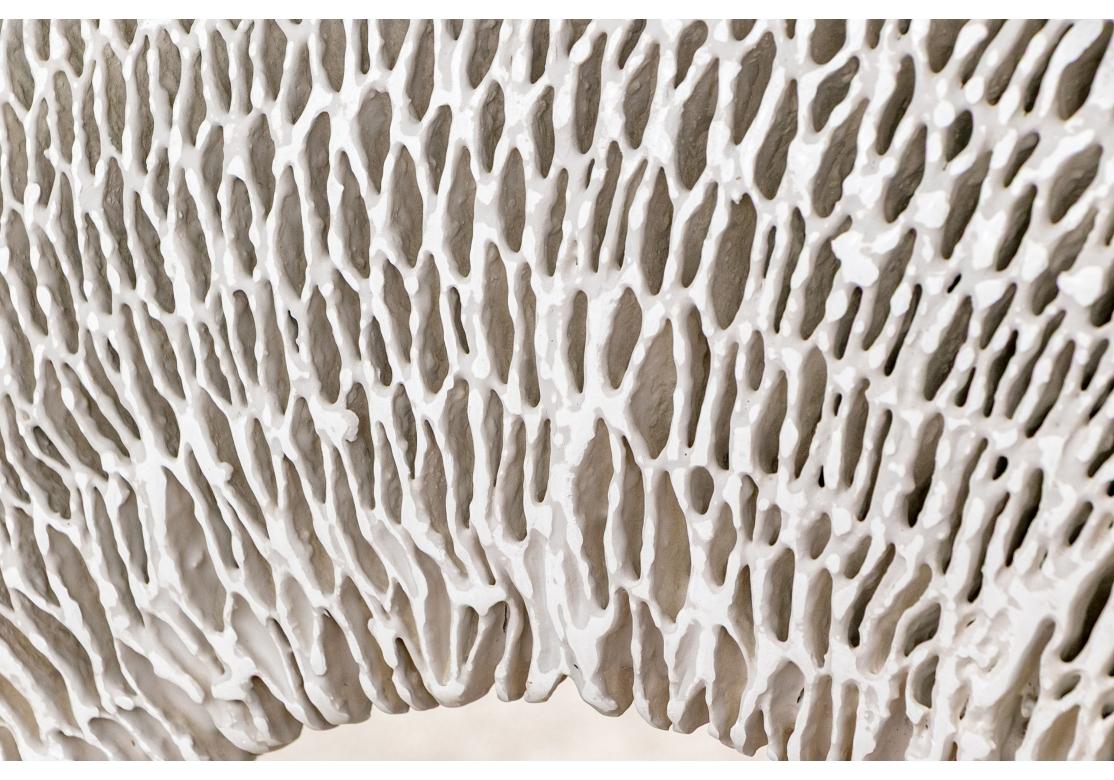 A spectacular hand cast resin Mirror in Organic Modern form with gesso finish.  The Mirror with a very thick intricate styling reminiscent of organic structure as in honeycombed wasp nests, coral and bone and is inset with a 15” diameter flat round