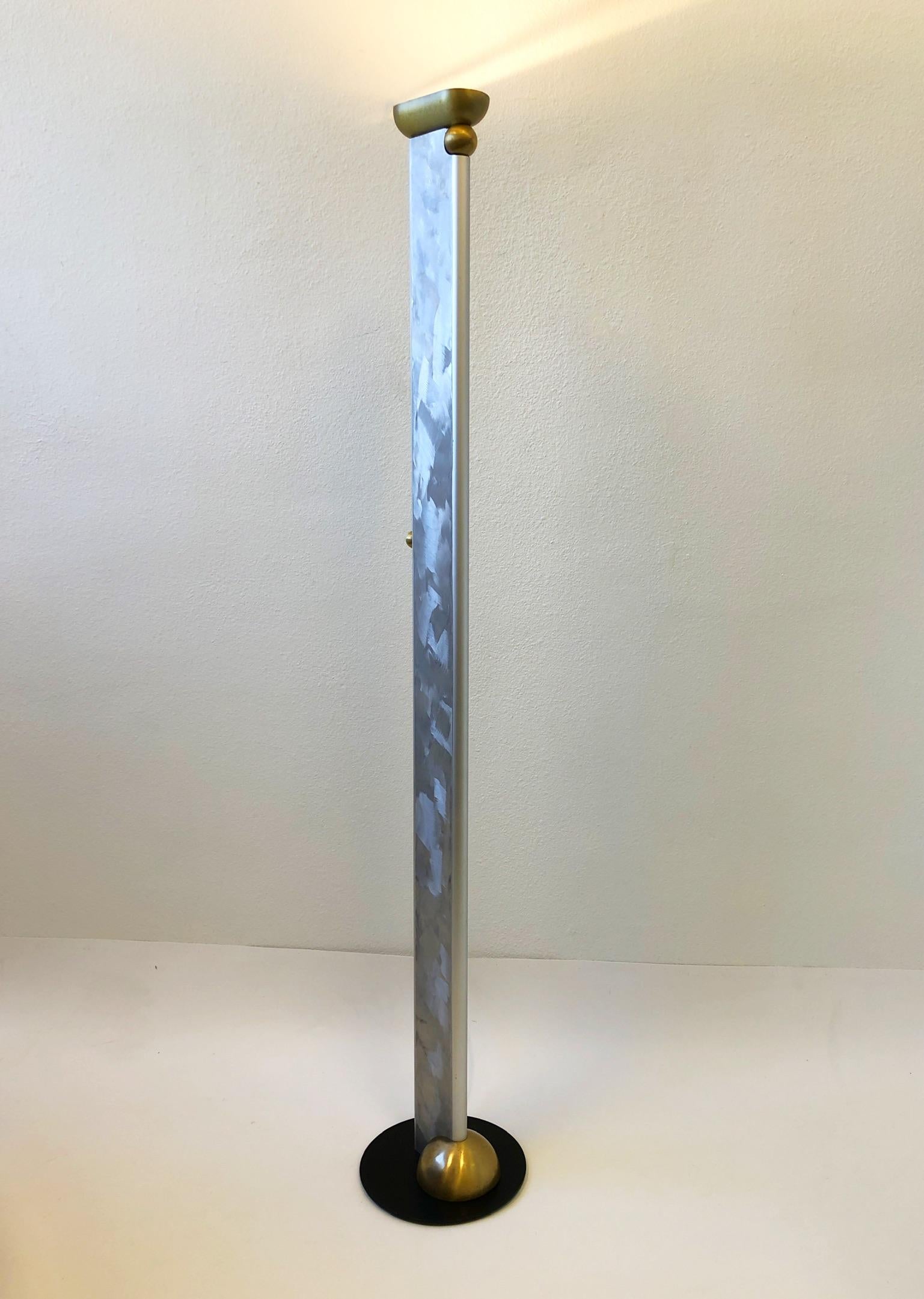 Studio hand sign and number 21 torchiere floor lamp by Ron Rezek.
The top part is adjustable.
Constructed of aluminum and Satin brass, it takes a halogen tube bulb 300w max.
It has a built in full range dimmer on the side.
Measurements: 12”