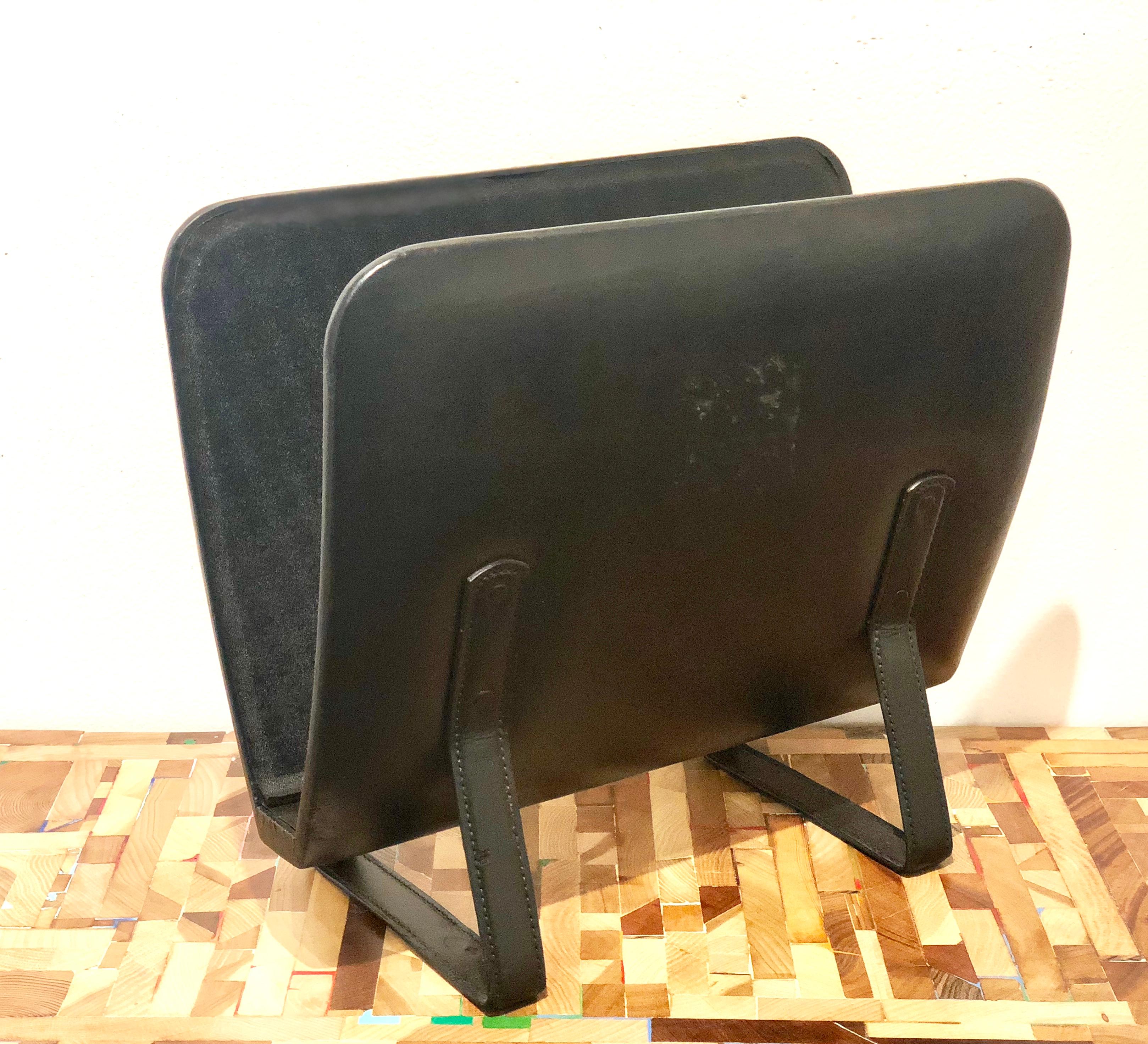 Beautiful black leather hand-stitched magazine holder by Jacques Adnet, circa 1950s. The condition on one side show some wear due to age overall not bad except for the mark shown in the picture.