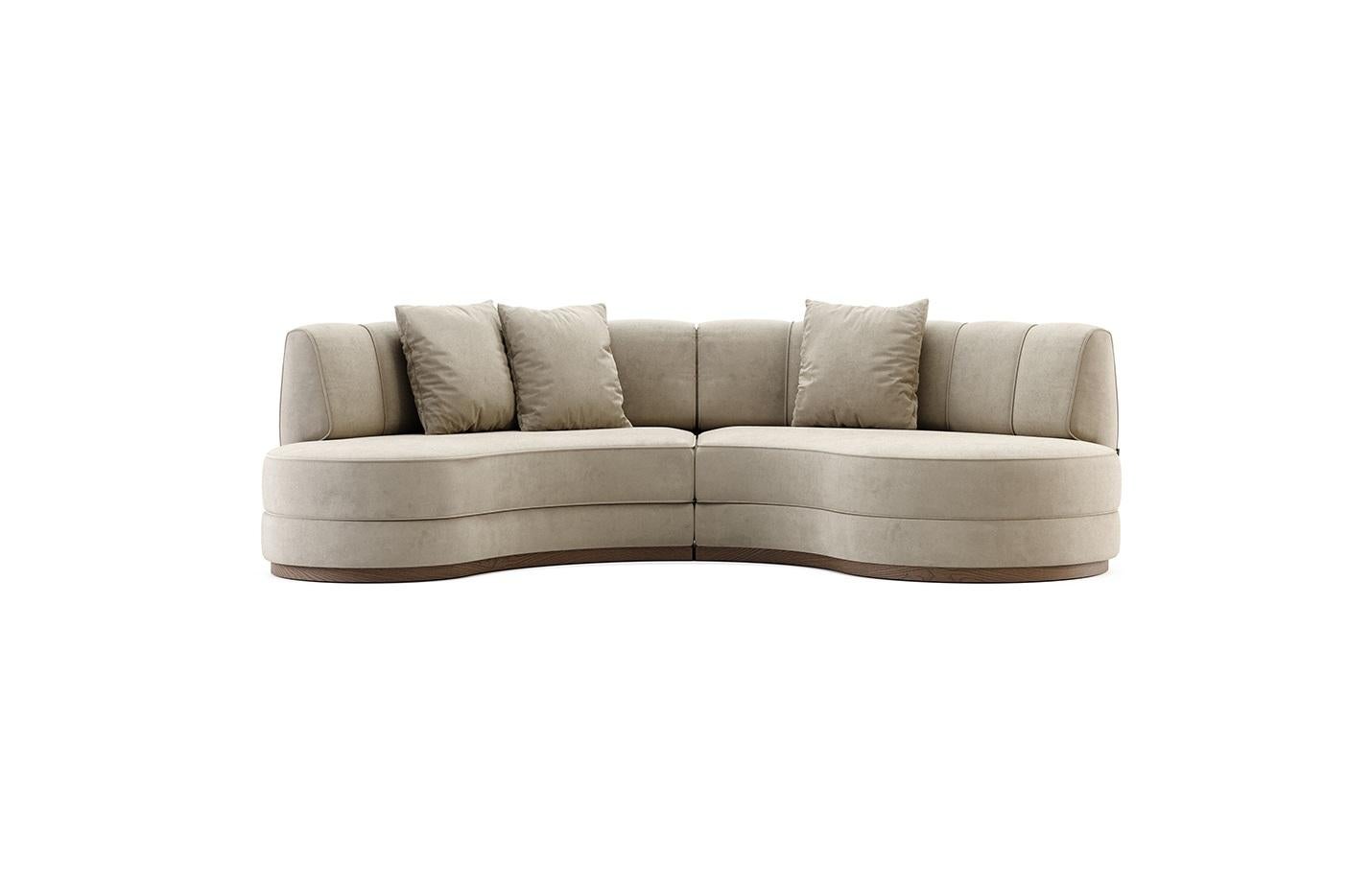 Mid-Century Modern inspiriertes Sektionssofa mit geschwungenem Design und luxuriösem hellgrauem Samtstoff. Gestützt von einem Sockel aus nussbaumfarbenem Holz.
Der für dieses Sofa vorgeschlagene Samt ist schmutz- und wasserabweisend. Dieses Sofa