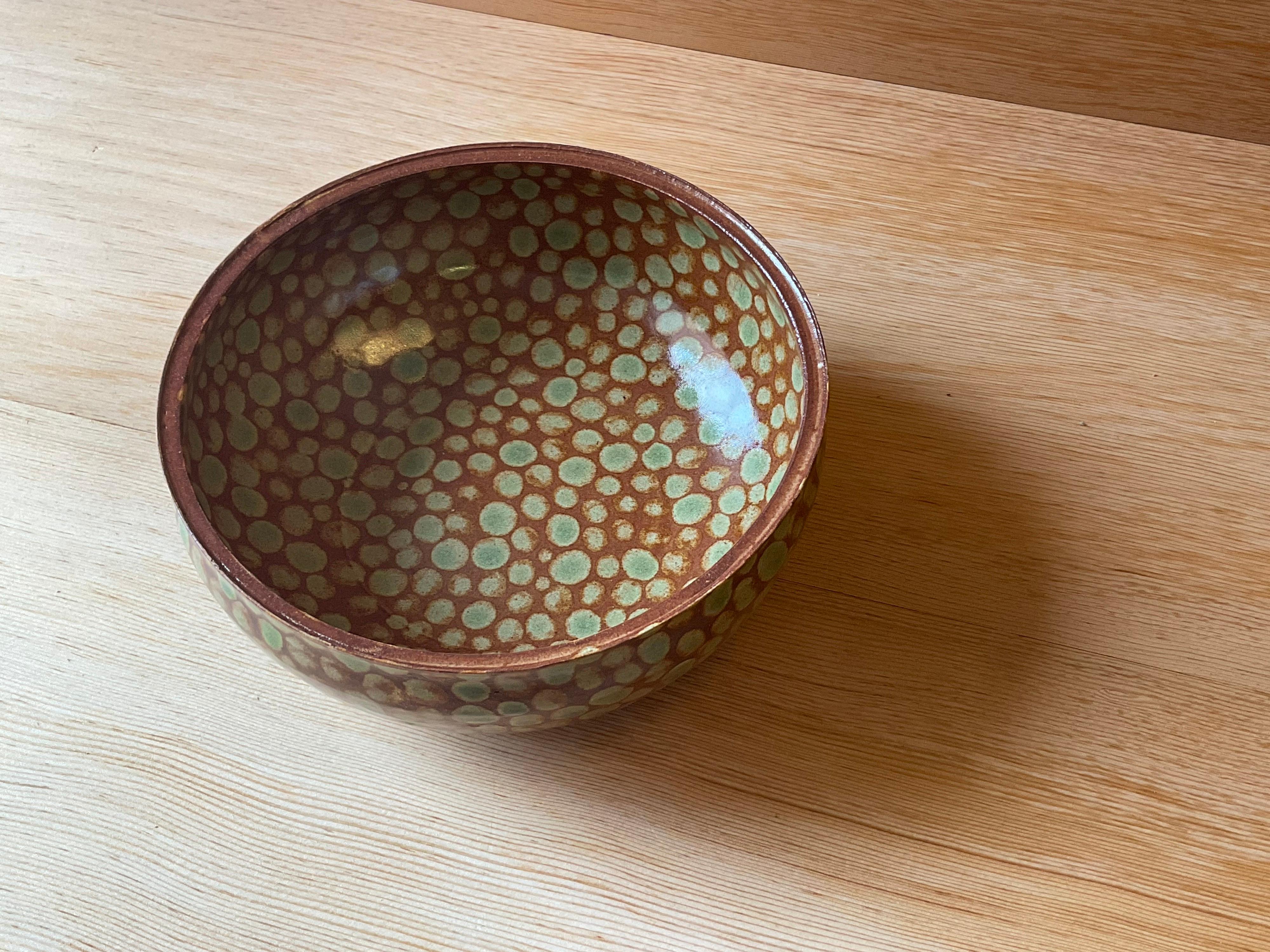 Thrown stoneware soup bowl with squared rim. Glazed green dots on amber glaze. Slight matte finish. Measures: 6.5” x 6.5” x 3”.

Made in Tribeca, NYC, by artist Lana Kova.