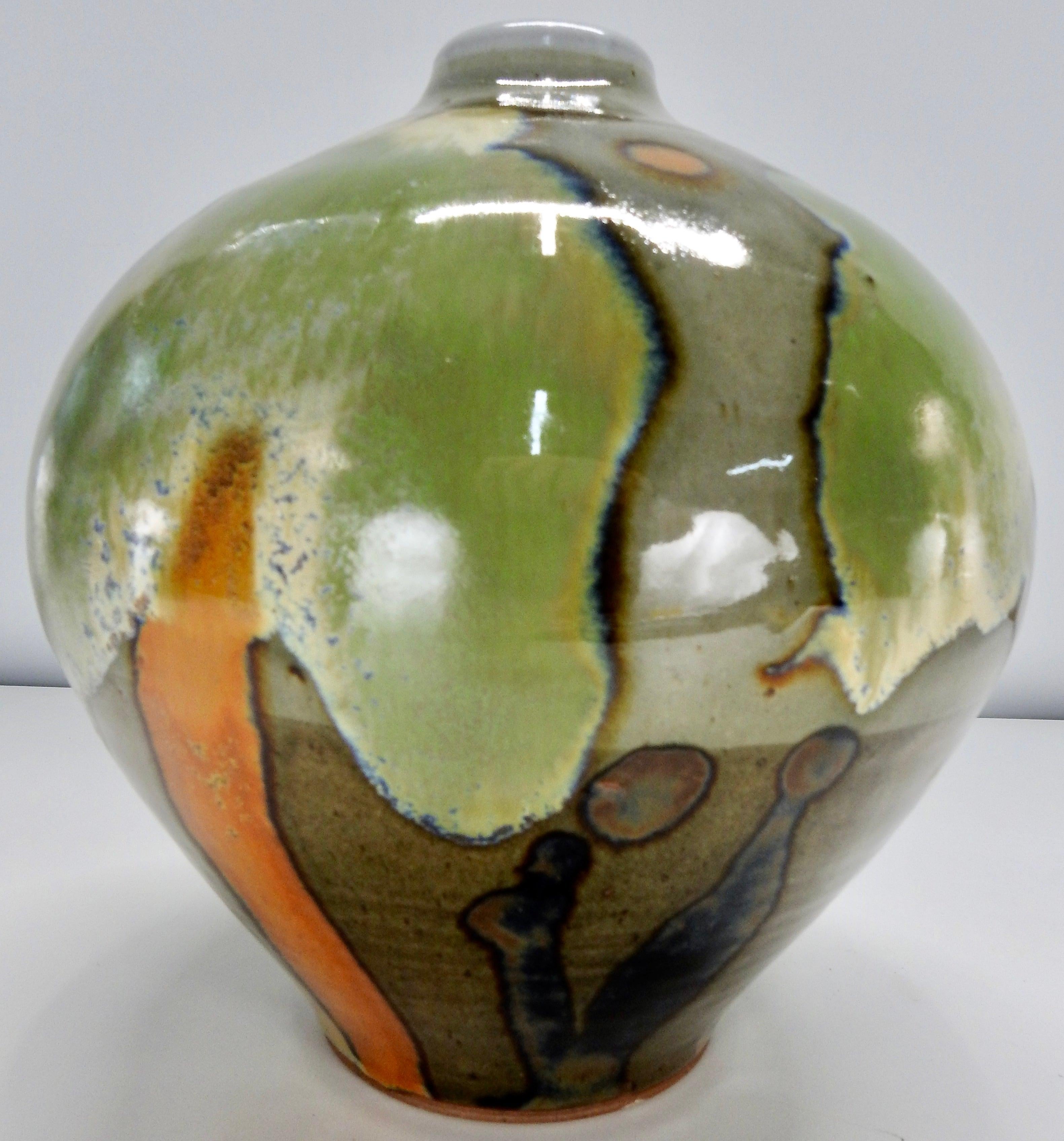 Rich earth tones compliment this hand thrown pottery vase by Sinclair Ashley. If you look closely, you will see tree forms in his design. Ashley was a well-known potter and instructor from Chattanooga, Tennessee. He primarily used colors such as