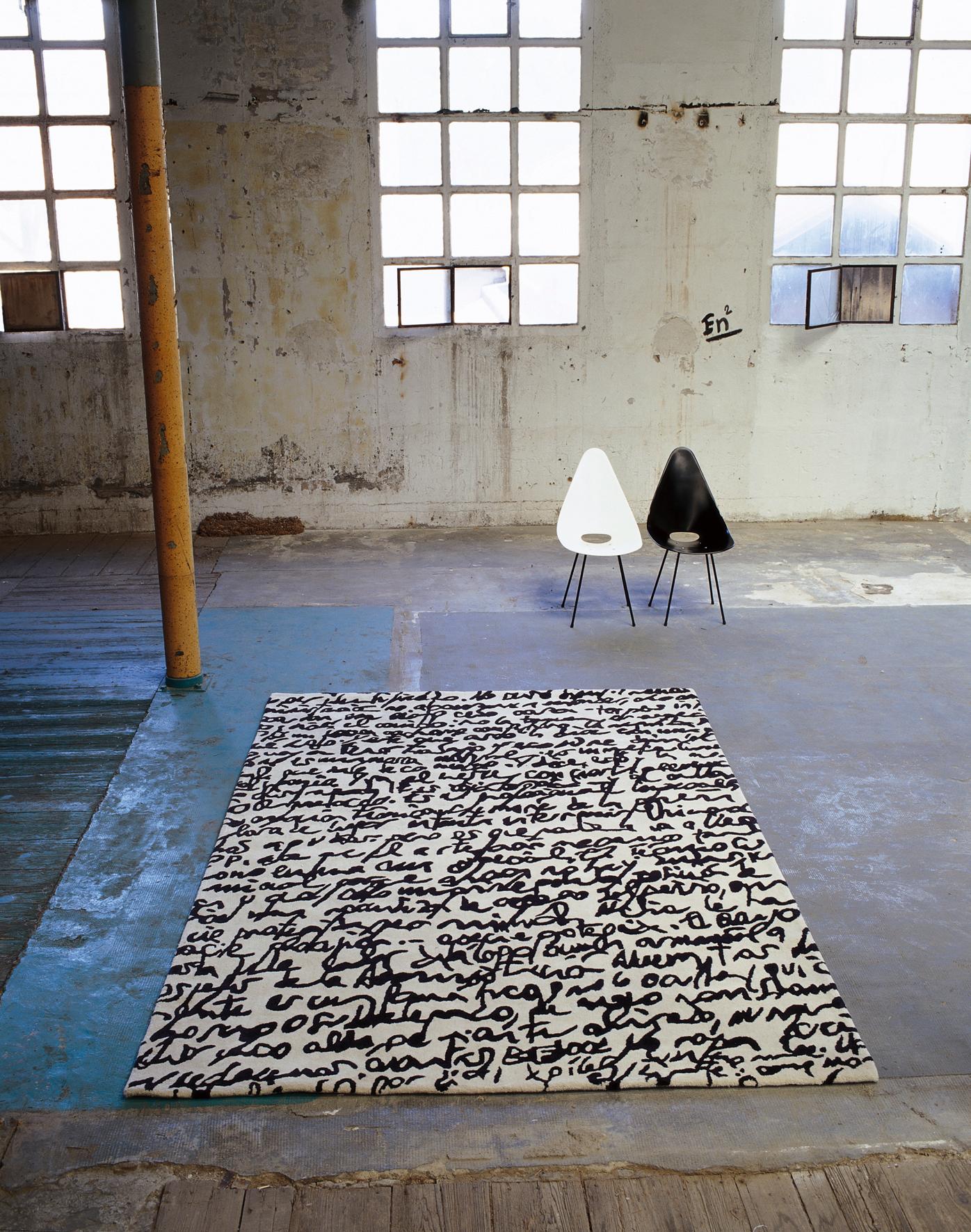 Hand-Tufted 'Manuscrit' rug by Joaquim Ruiz Millet for Nanimarquina.

Executed in 100% hand-tufted New Zealand wool. The absence of color makes each of these rugs a dichotomy, a canvas in its own right. The stark contrast of black and white