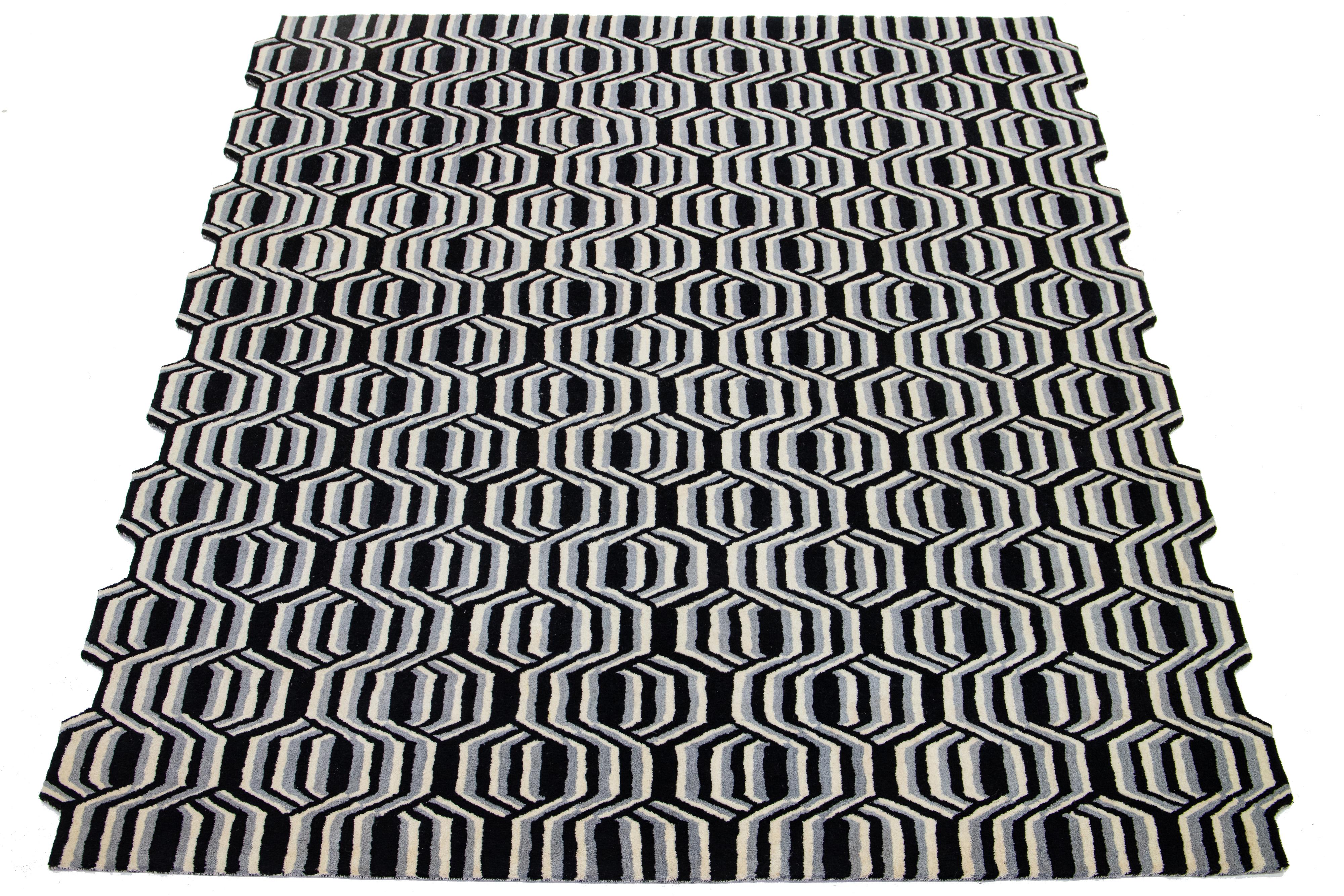 This beautiful, modern hand-tufted wool rug part of our Laura Gottwald for Apadana Collection features gray, black, and ivory fields. This Freestyle design: Overlapping hexagons create Freestyle’s crisp, quirky graphic pattern. 
People unconsciously