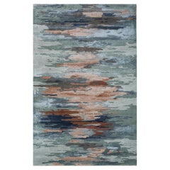 Alfombra de lana y viscosa tejida a mano en tonos plateados, azules y rosas, diseño abstracto