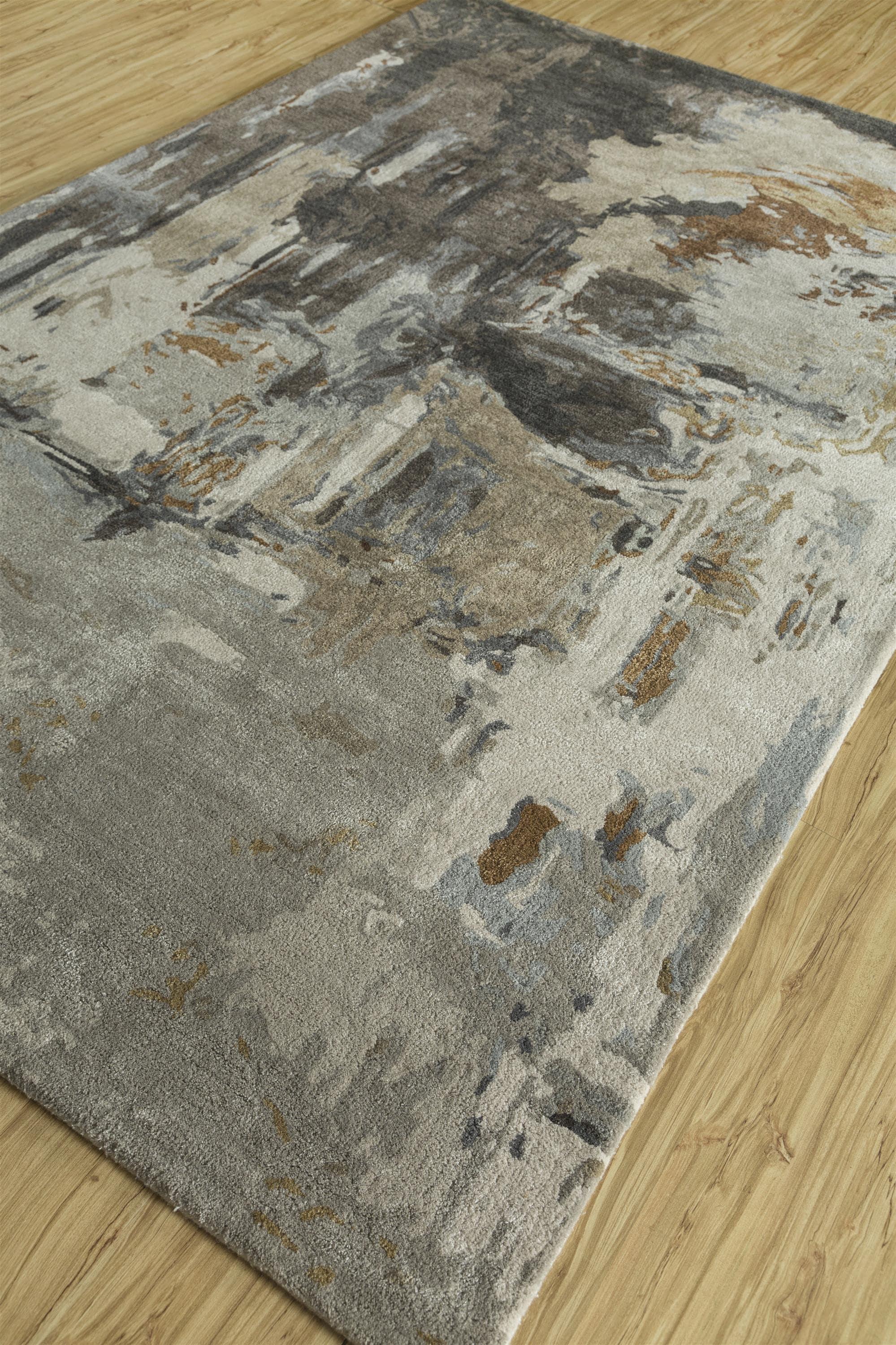 This 5' x 8' hand-tufted wool and viscose rug from Jaipur Rugs presents a refined blend of classic gray and liquorice tones, offering a contemporary yet timeless look. The artistic abstract design adds texture and depth, enhancing any living space,