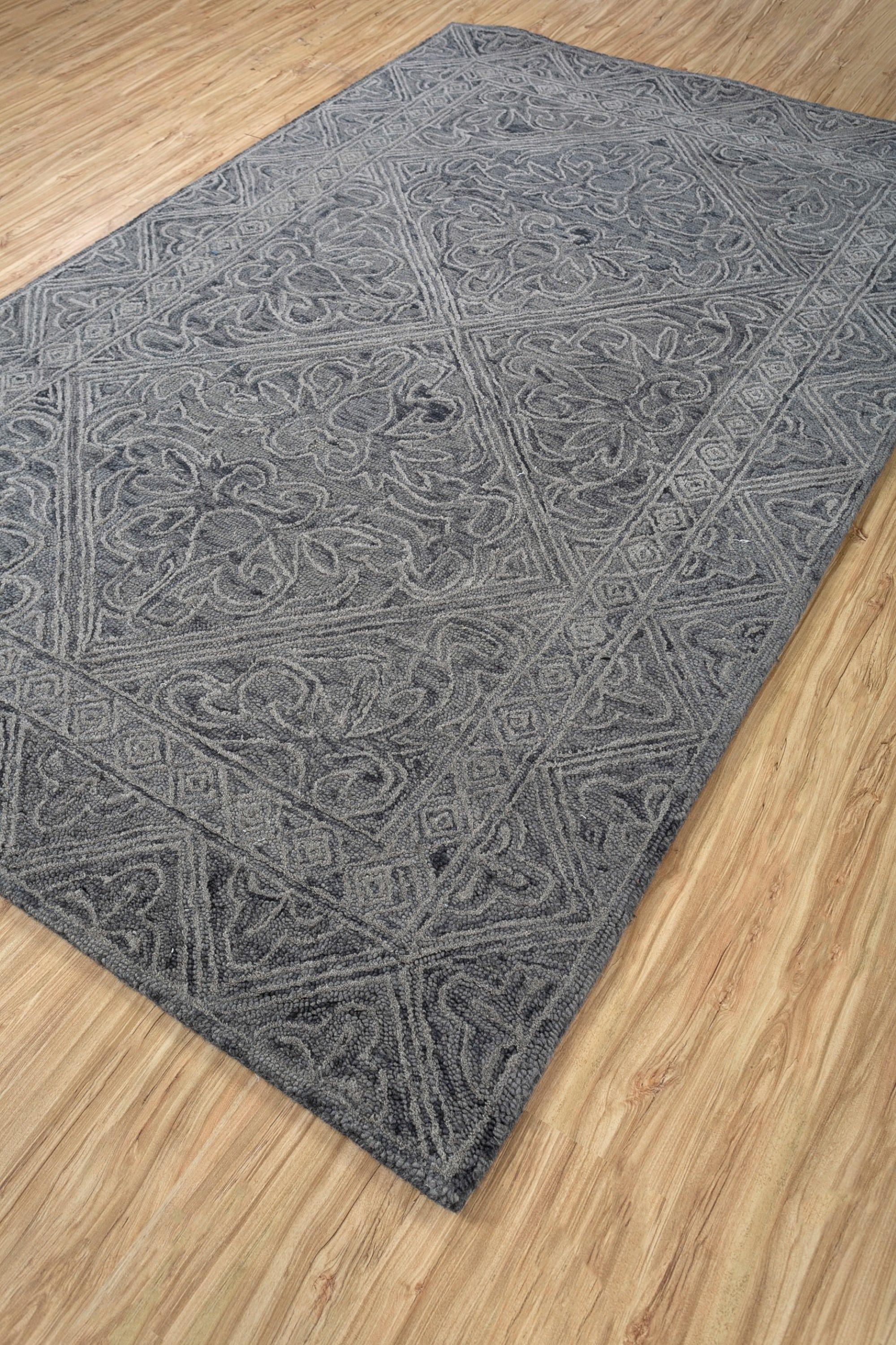 Dieser 5' x 8' große, handgetuftete Wollteppich von Jaipur Rugs zeichnet sich durch eine raffinierte Farbpalette aus Ebenholz und Dunkelgrau aus und ist ideal, um jeden Raum mit zeitgenössischer Eleganz zu gestalten. Sein abstraktes Design zeigt