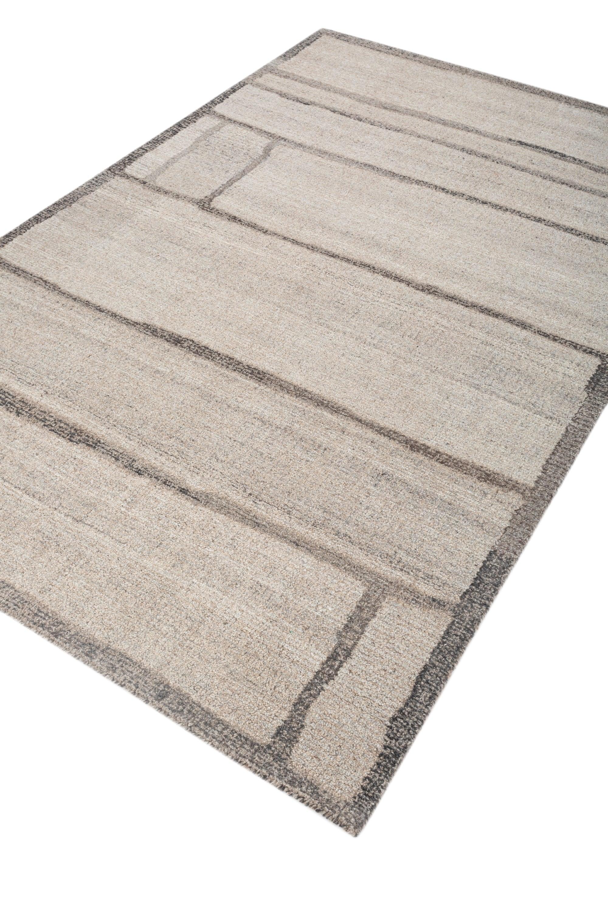 Dieser 5' x 8' große, handgetuftete Teppich von Jaipur Rugs zeichnet sich durch eine raffinierte Farbpalette aus natürlichem Grau und Anthrazit aus und präsentiert ein abstraktes, zeitgenössisches Design. Der Teppich aus hochwertiger Wolle bietet
