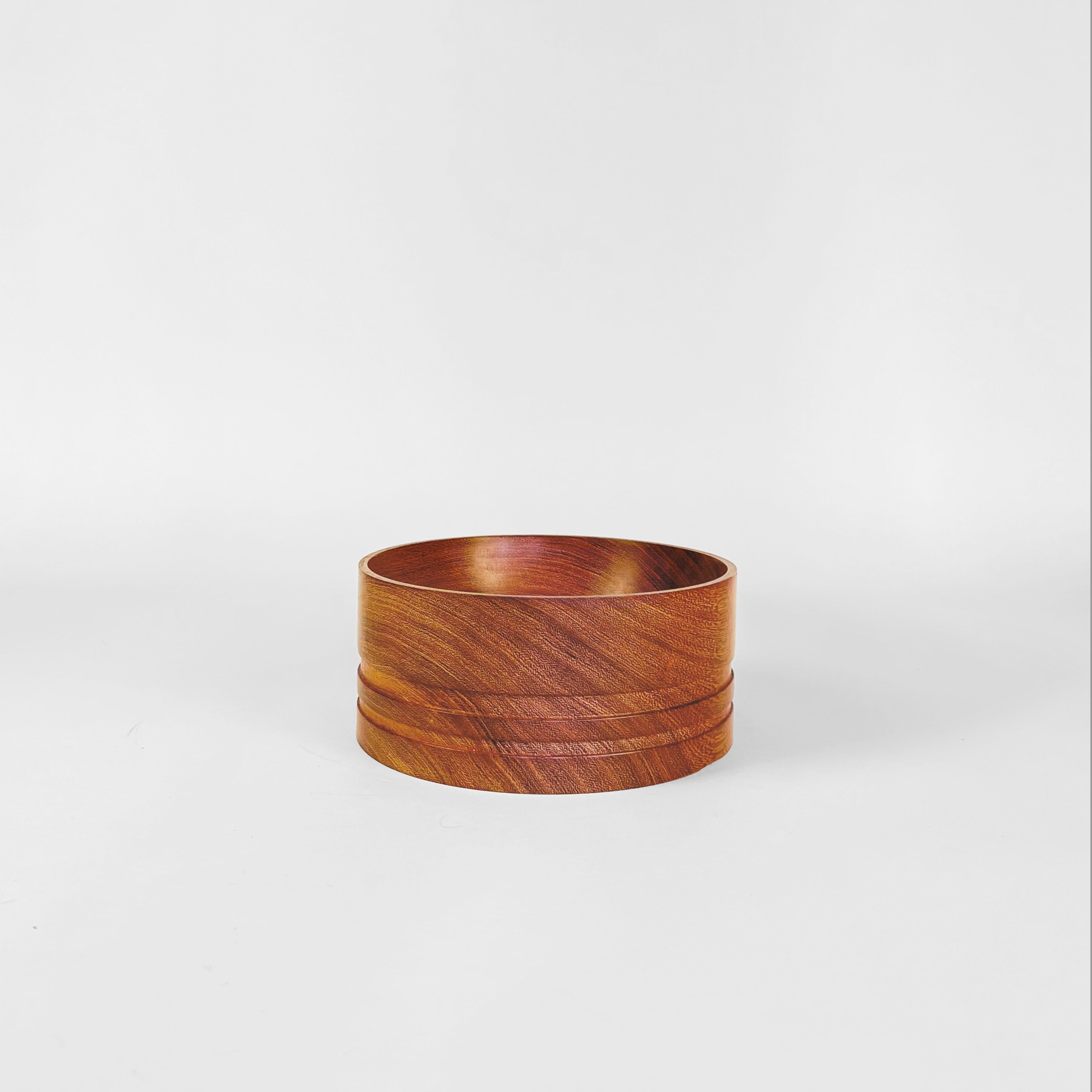 Hand-turned wooden bowl by Alta Pampa, Argentina.
The piece is made in Quebracho (Hardwood) and it shows two perimetral grooves that run on the lower half.
Stamped on the base.