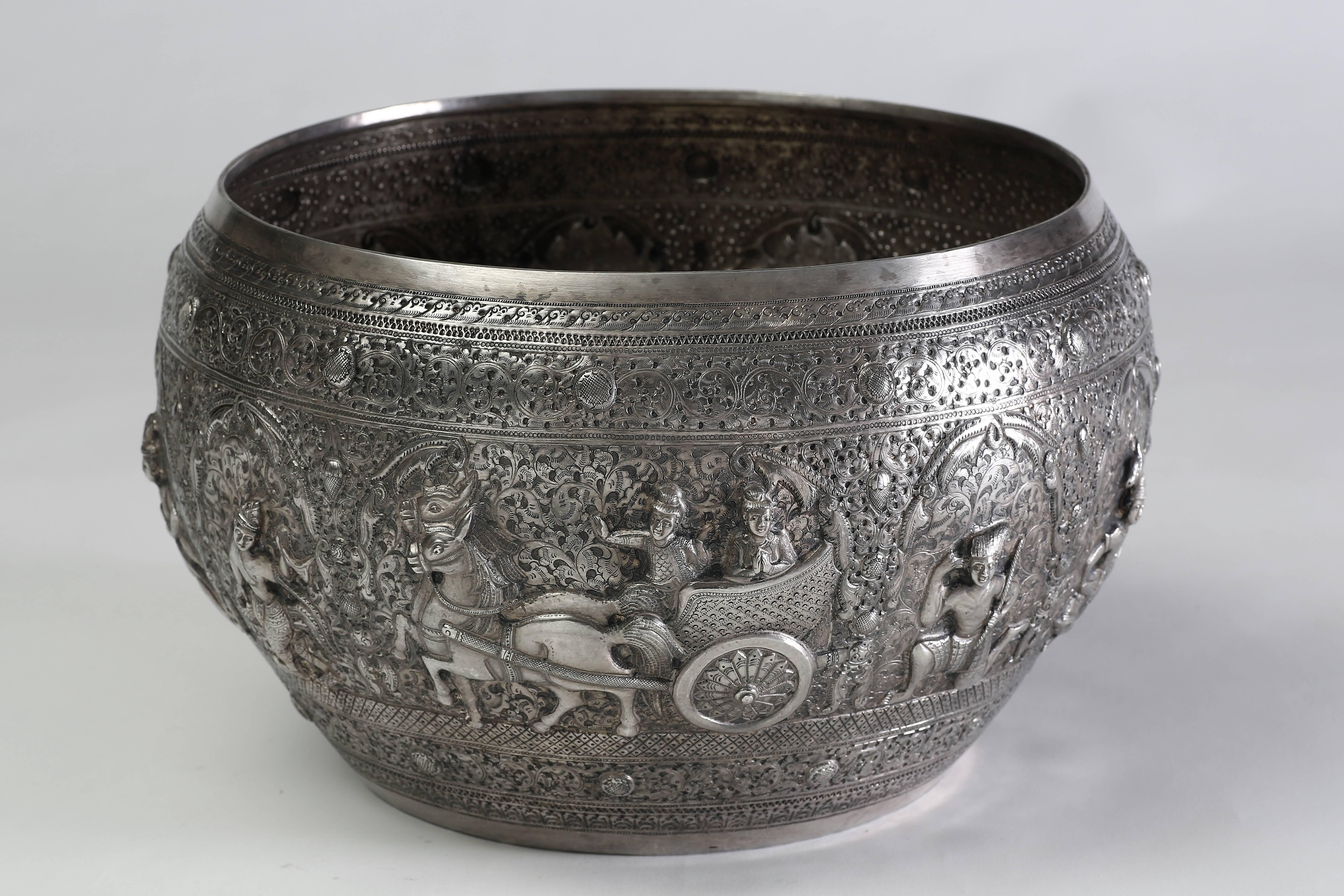 The fine silver bowl depicts scenes of various adventures from the Jataka story, hammered into the silver in high relief and repousse and surrounded by relief floral decoration.
The extraordinary silver bowl is traditionally used for ceremonial or