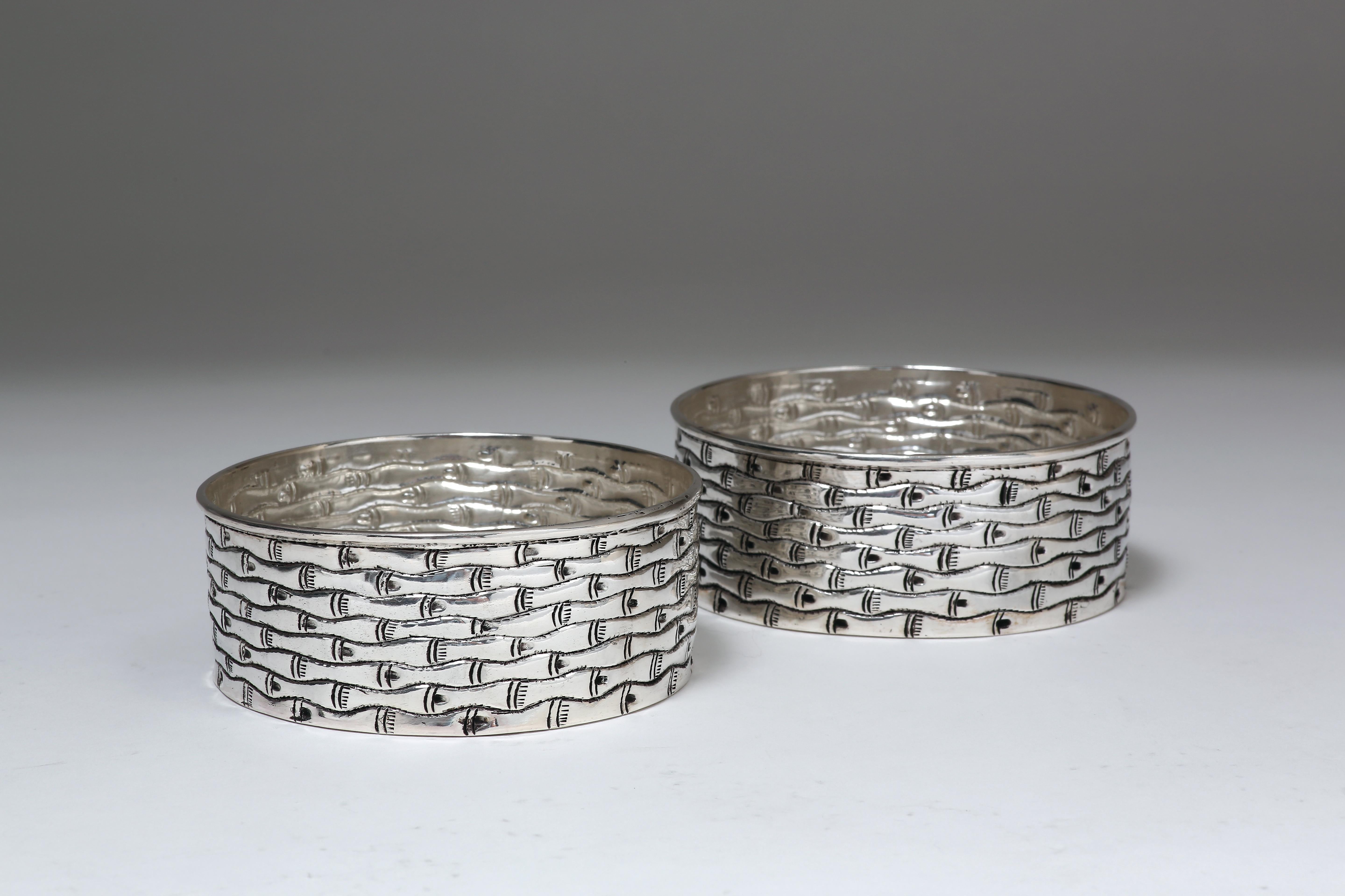 The contemporary solid silver wine coasters are finely chased with bamboo motif, sold as a pair and available in other chased motifs.
The silver is 90% pure.