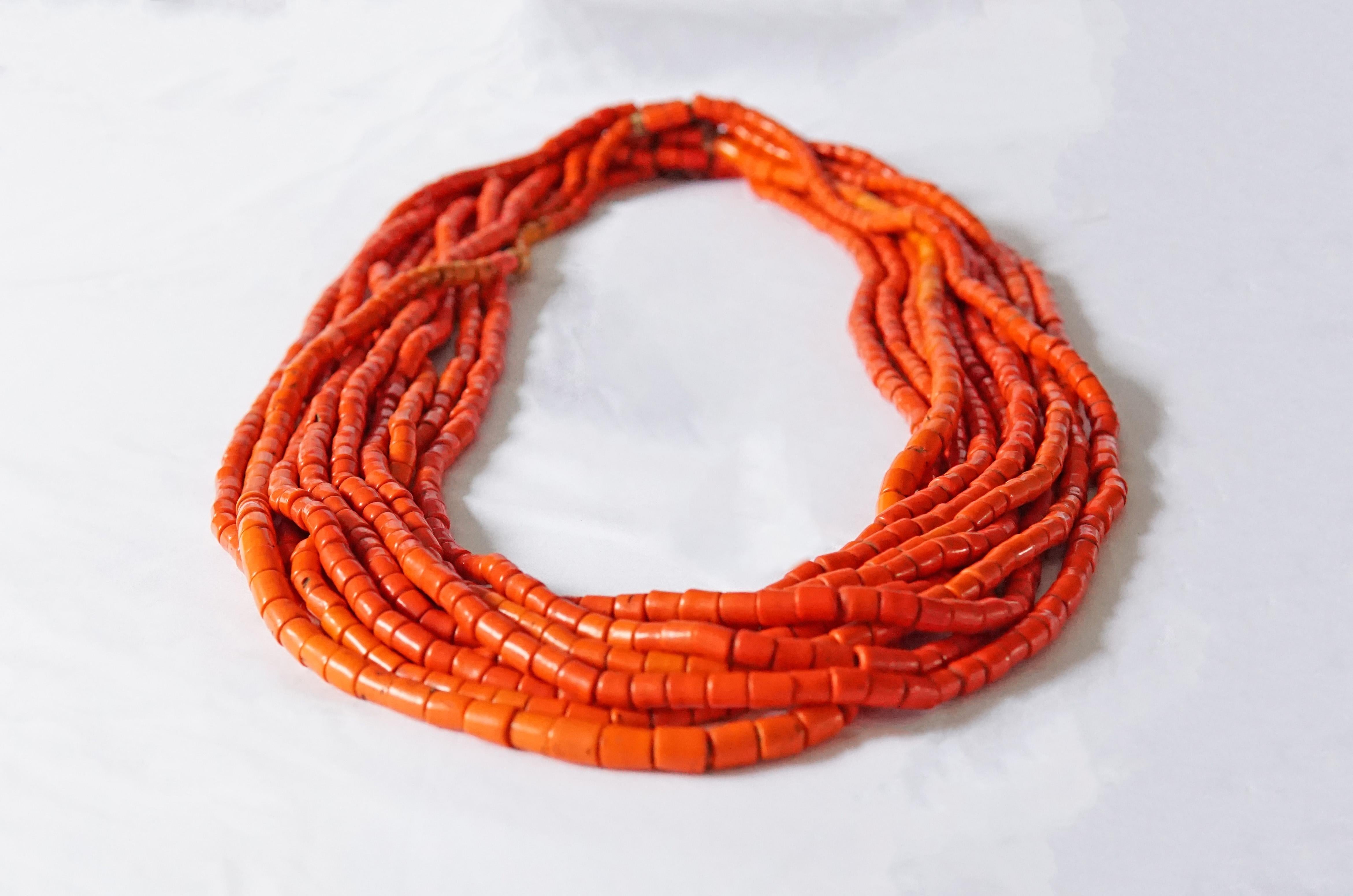 A 10-strand necklace hand-crafted from red-orange Naga beads from the early 20th century and strung with natural fibers. Necklaces such as these were a status symbol and an important item amidst women dowry. The beads are 