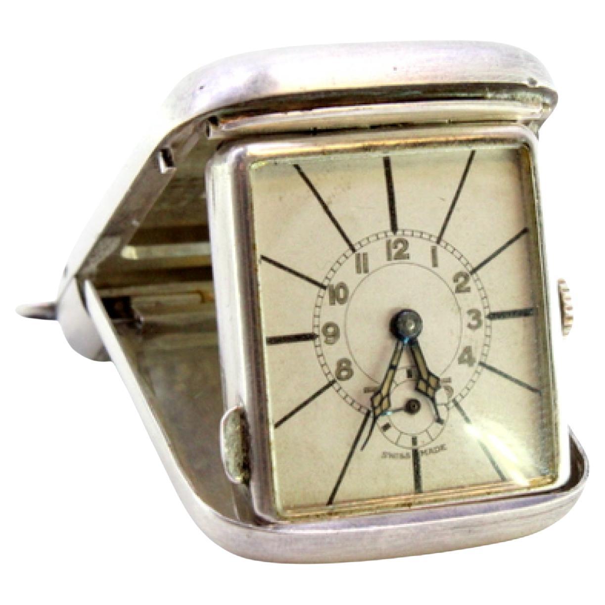 Hand-wound travel clock in guilloche silver on the casing and suspension ring