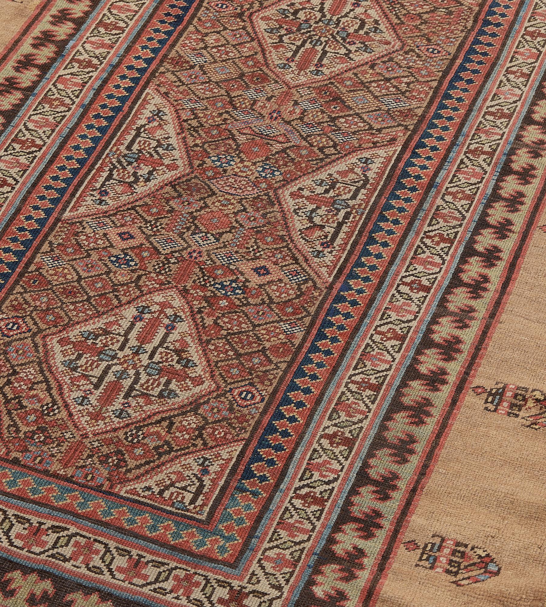 This antique, circa 1870, Persian Serab runner has a camel-brown field with a dense polychrome lozenge lattice around a column of four ivory lozenges each containing a central rosette issuing angular floral vine, three similar ivory part lozenges at