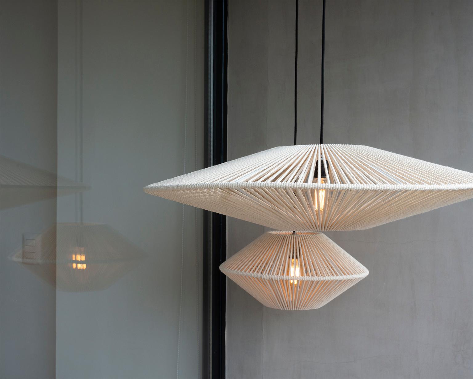 The Handwoven Bebop Tall Cotton Light Screen from León León Design in Mexico City is an exquisite and distinctive creation that combines artistry and functionality. This unique lamp showcases the exceptional craftsmanship and attention to detail