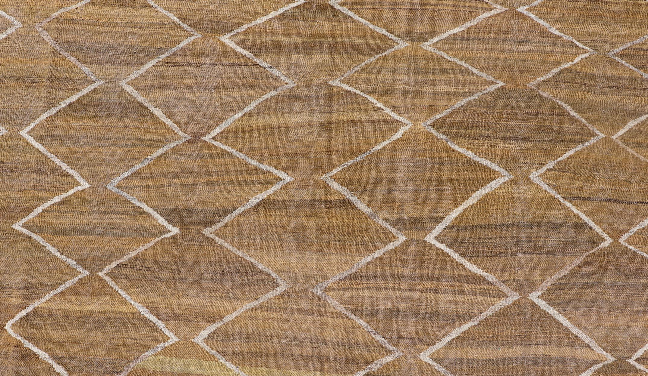 This flat-weave kilim has been hand-woven. The rug features a modern diamond design, rendered in marigold, ivory and brown tones; making this rug a superb fit for a variety of classic, modern, casual and minimalist interiors.

Modern Kilim rug,