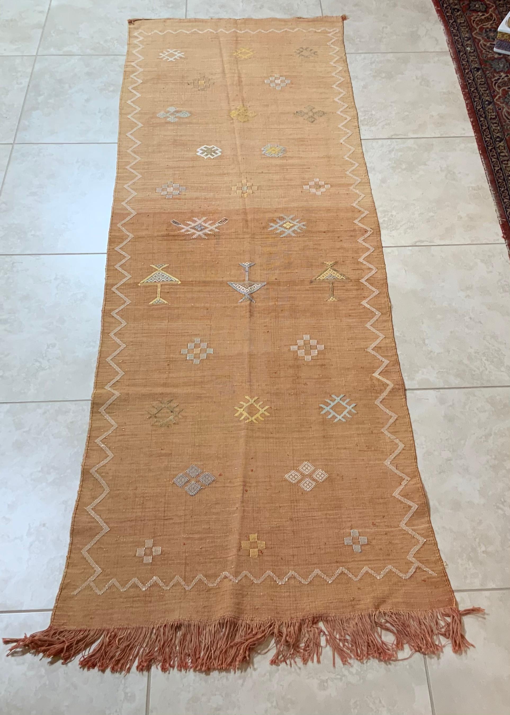 Beautiful handwoven rug runner made of cactus silk with soft multi-color geometric motifs on a Salomon - color background, nicely feel to touch. Great decorative addition for any room.