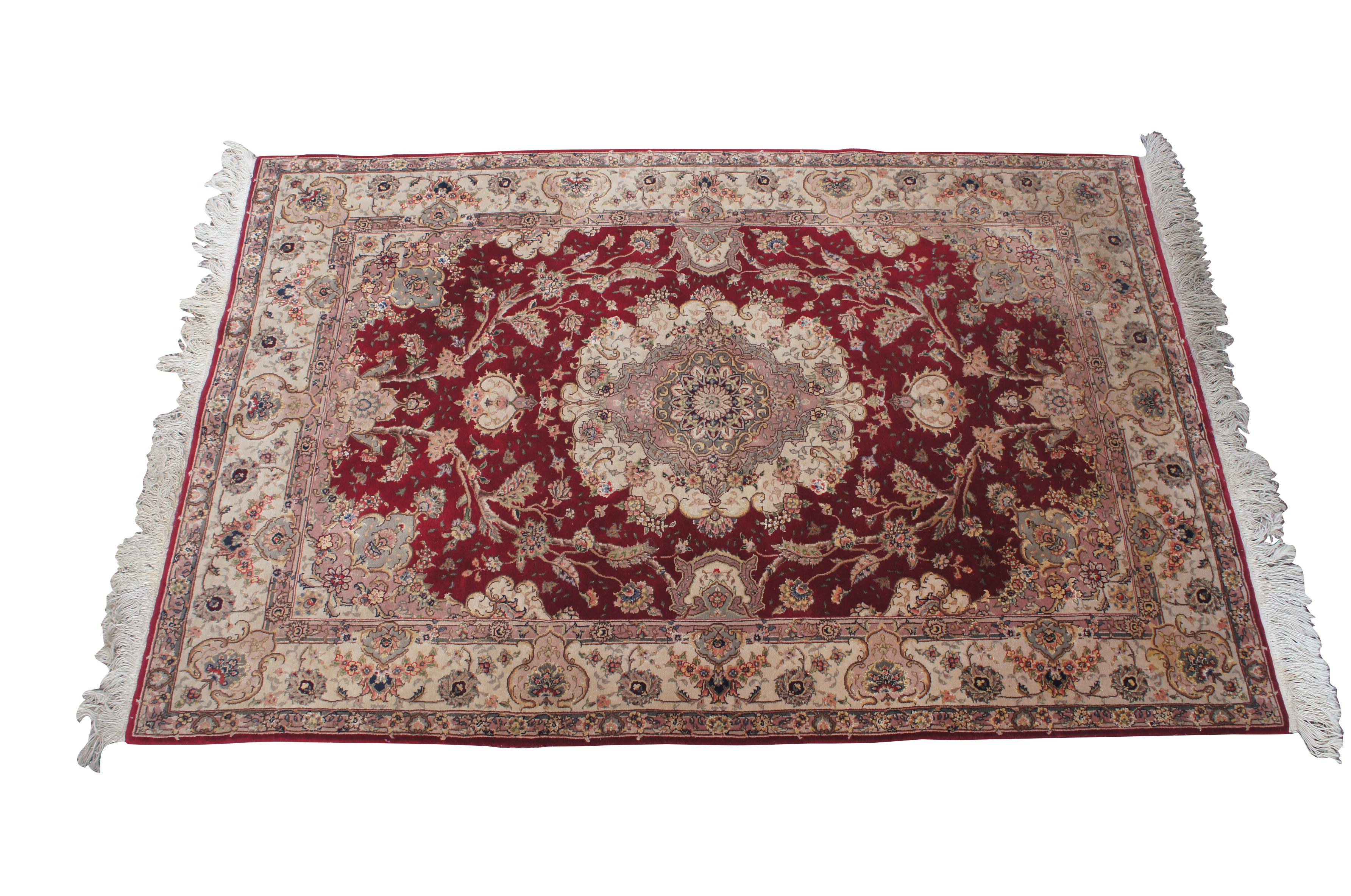 A genuine hand woven oriental Sino Tabriz area rug. Made from silk and wool with a red field showing beige and pink accents.  The vibrant geometric medallion is surrounded by elegant floral sprays.  256 knots per square inch

Sino Tabriz rugs are