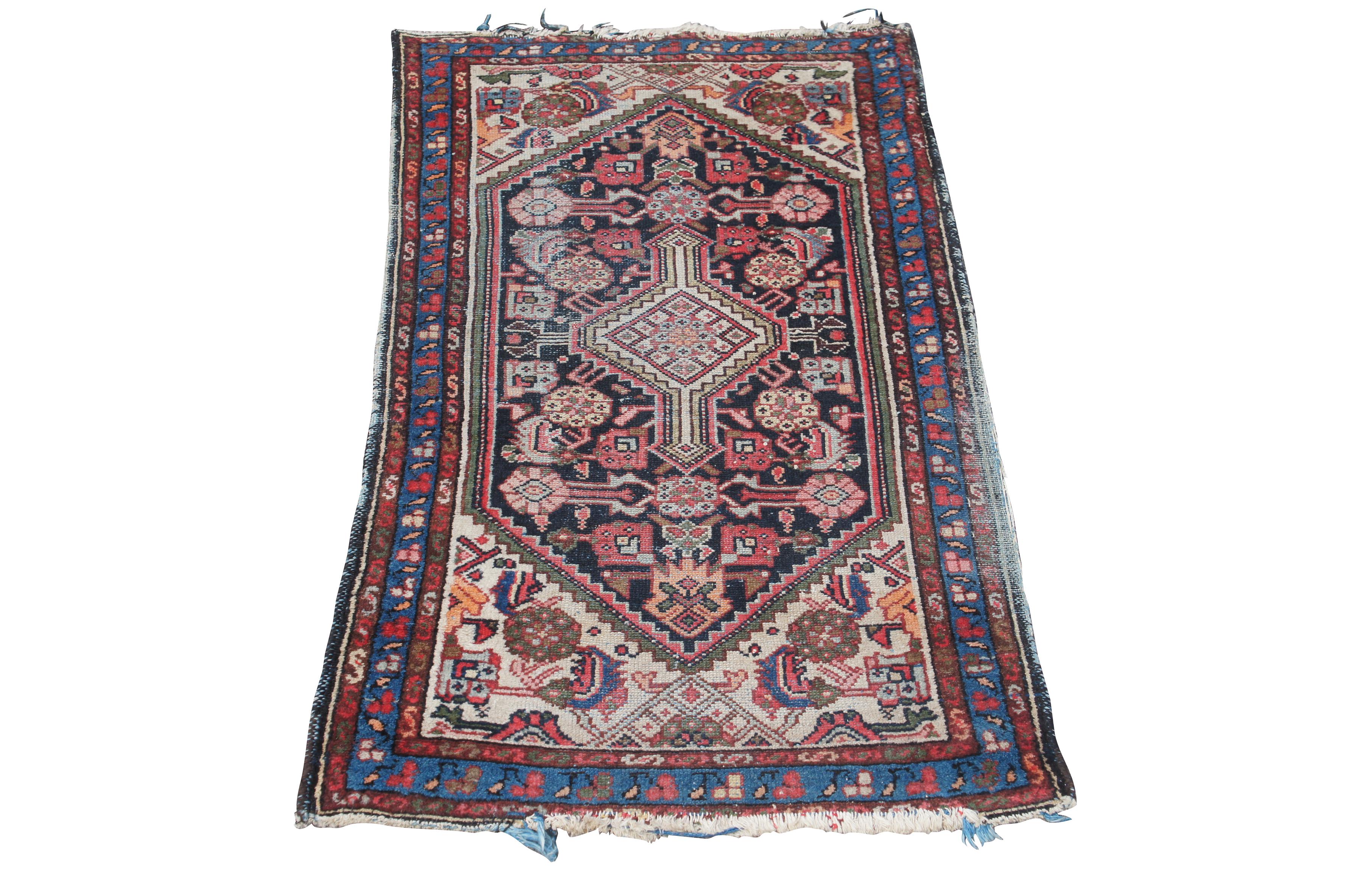 A lovely vintage prayer rug or mat. Features a geometric design with reds and blues accented by green, orange and beige.   

Persian Kurdish rugs are a type of rug that show Persian influence in both design and quality. They are finer, more