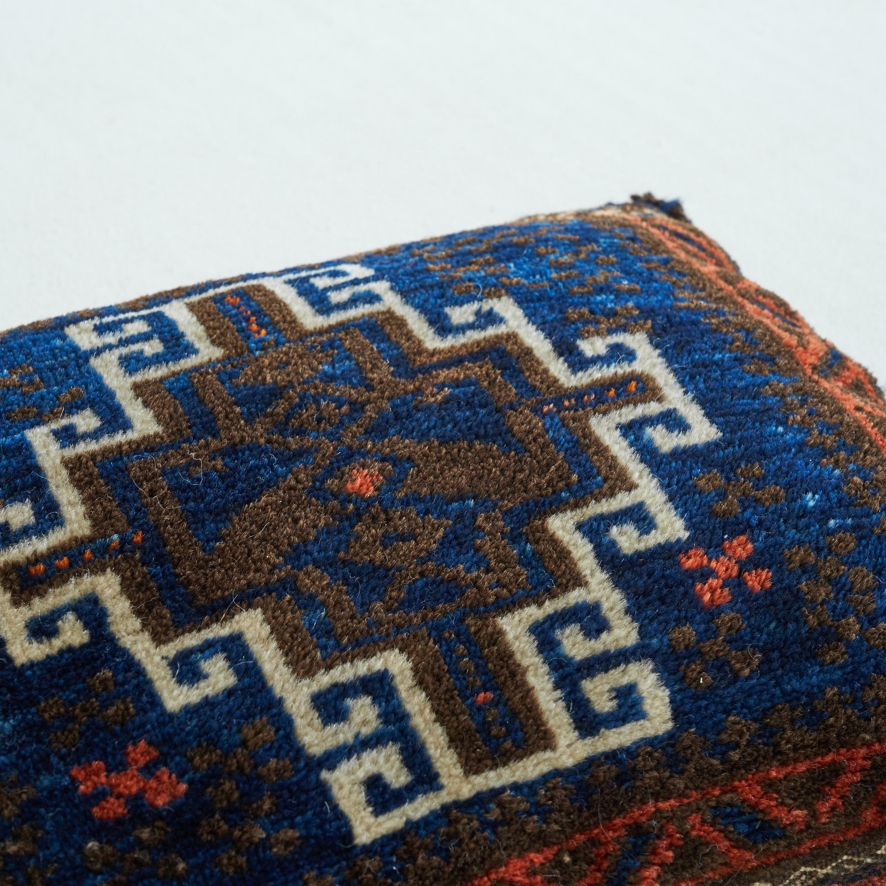 Hand Woven Persian pillow with Symmetrical Decor 1930s

Interesting small hand woven cushion from the first half of the 20th century with an interesting and distinct decor. The white ornamental lines are very elegant and the other red and blue