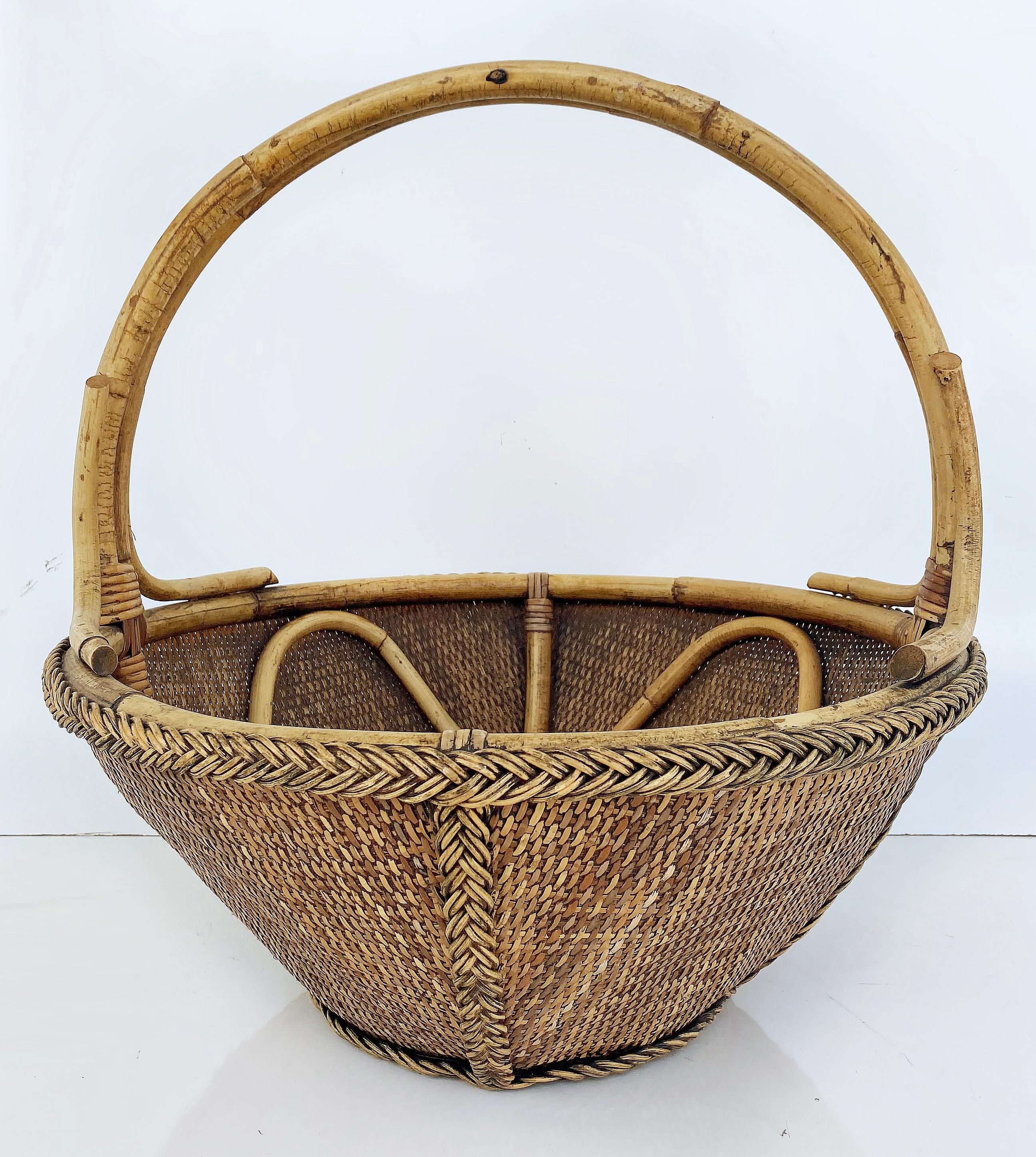Hand-Woven Rattan and Reed Basket with Handle and Braided Border

Offered for sale is a hand-woven rattan and reed basket with a handle and braided borders and details.