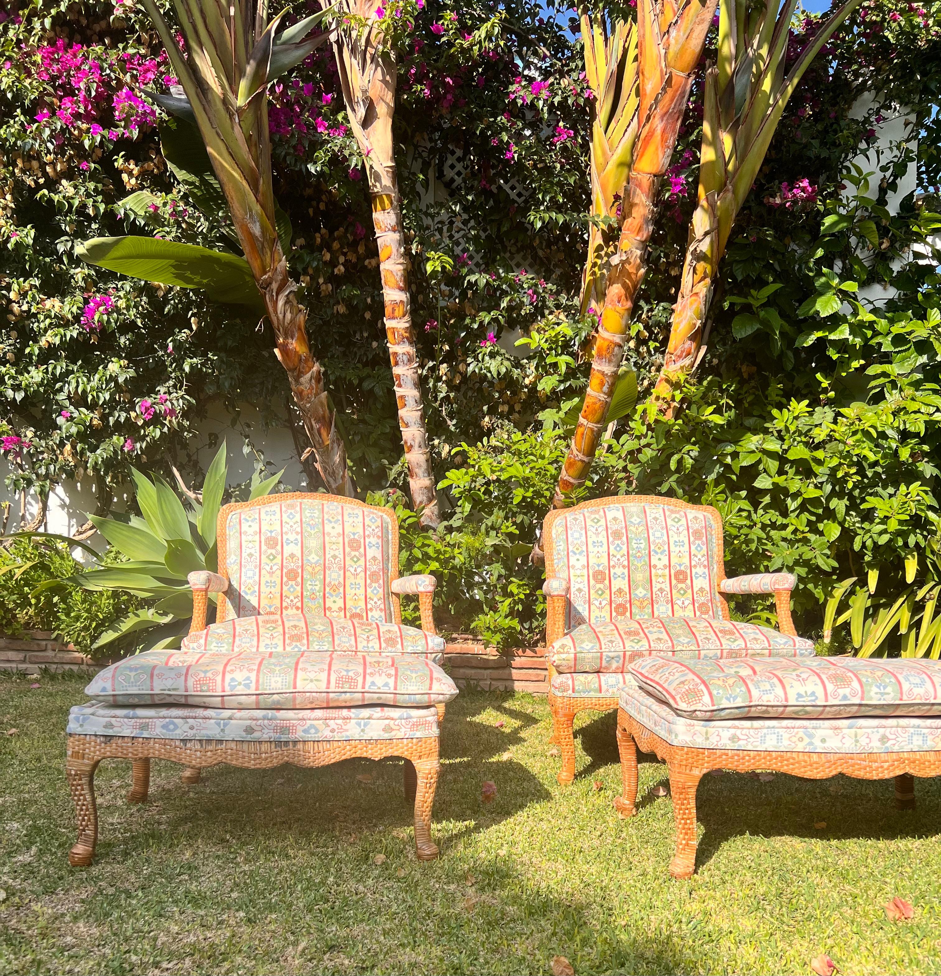 A pair  of Bergerer Arm Chairs with Matching Puffs hand woven ratan wicker cane.
  The chairs have double-sided woven panels of geometric cane topped with thick fitted loose seat cushions. The bespoke fabricfrom Gaston & Daniela Luxury textile