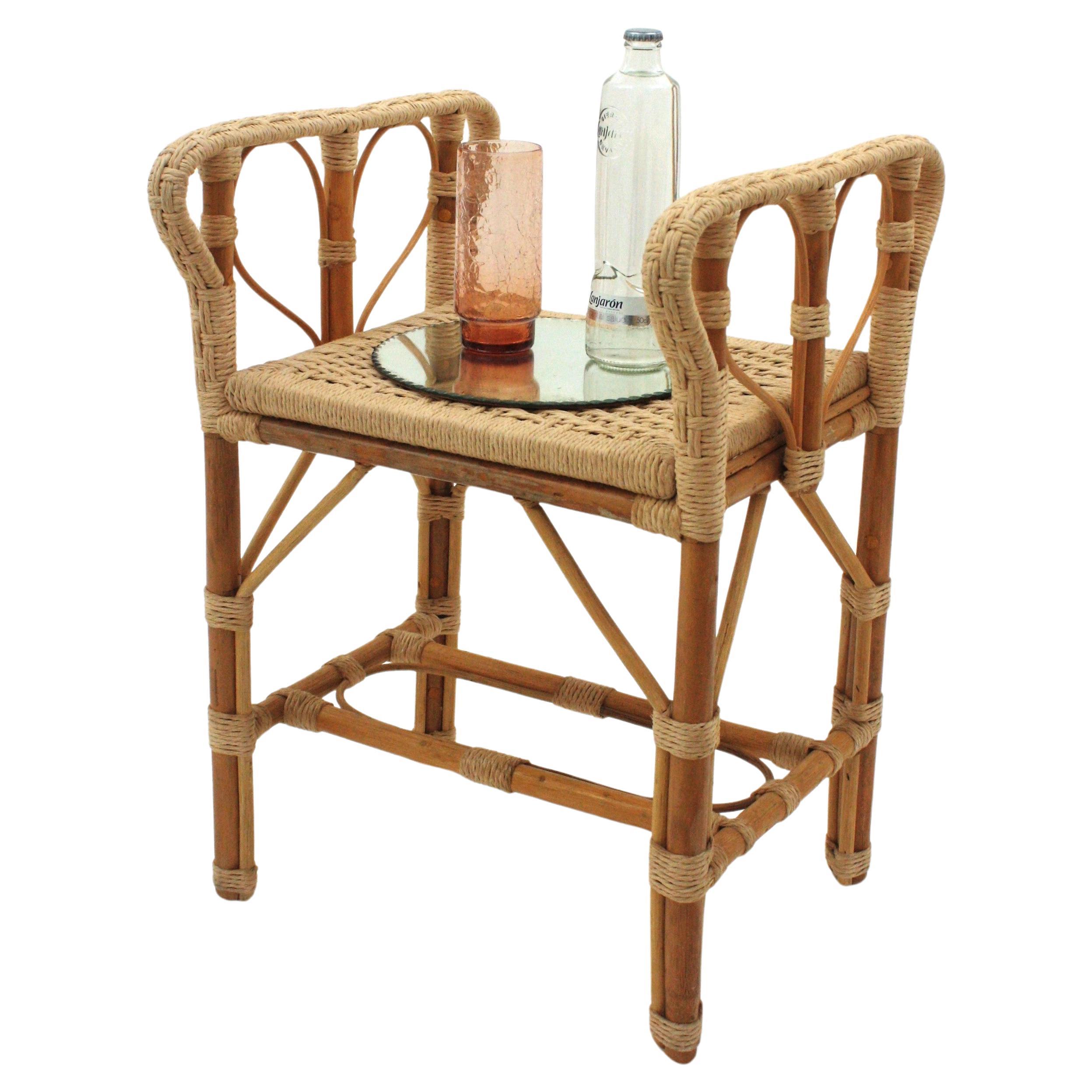 Stool with Arms / Throne Stool, Rattan, Rope
Hand-Braided rope and rattan rectangular stool or side table. Spain, 1960s.
Rare find.
On a rattan and bamboo structure this rectangular stool was upholstered with an artisan hand-woven rope work.
Rope is