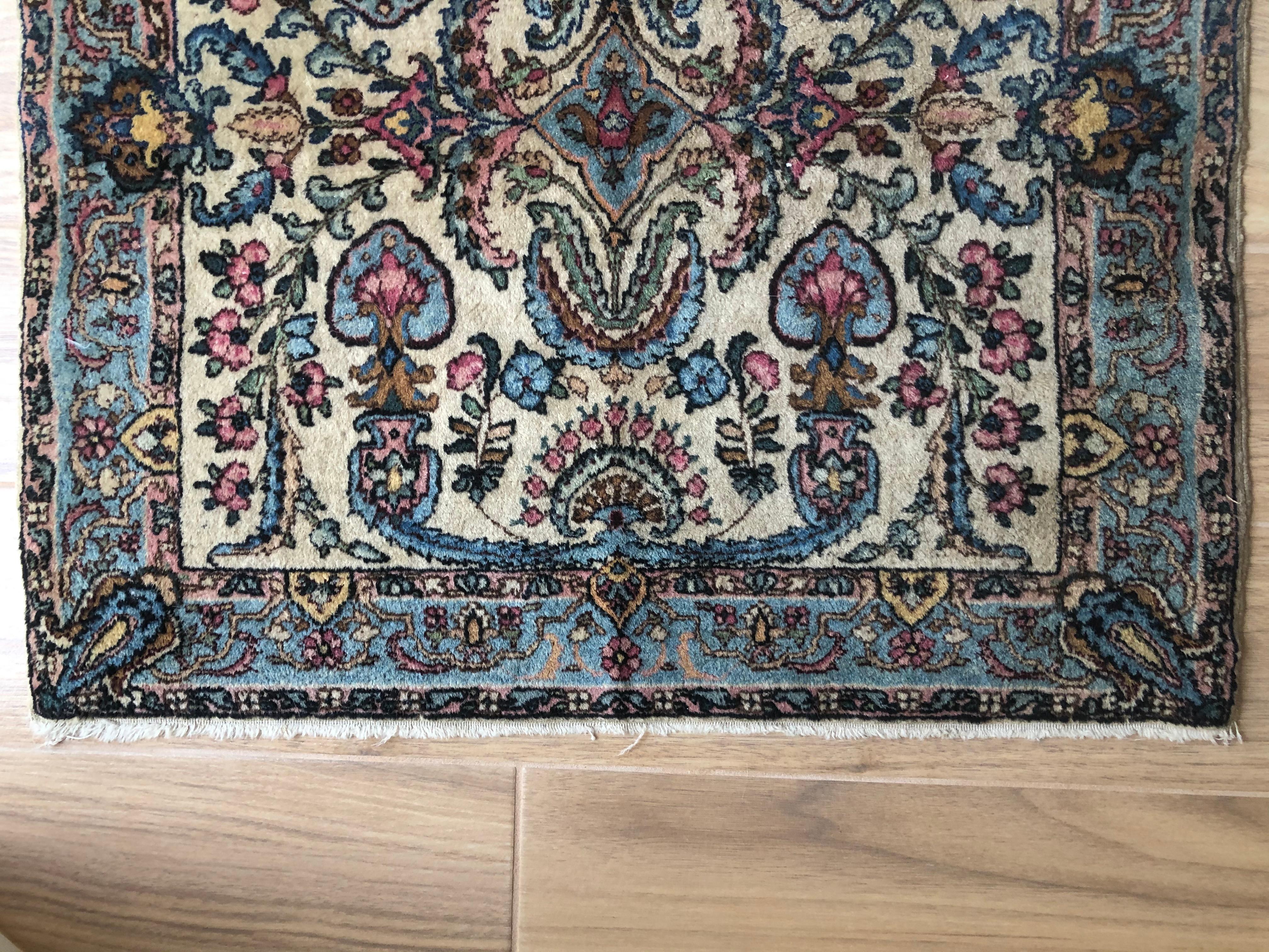 Beautiful rare handwoven fine wool square Persian rug with cream and beige background and accents of light blue and pink hues of floral designs and vines. Perfect for entrance or under a small coffee table, or house entrance.