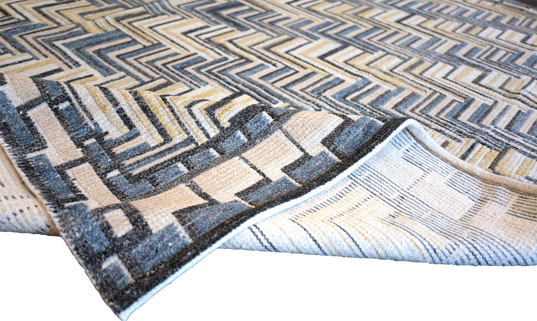 This handwoven Swedish deco style flat-weave rug has an organic yellow, blue, charcoal, and white geometric pattern, in a border of blue, taupe, and charcoal dashes.