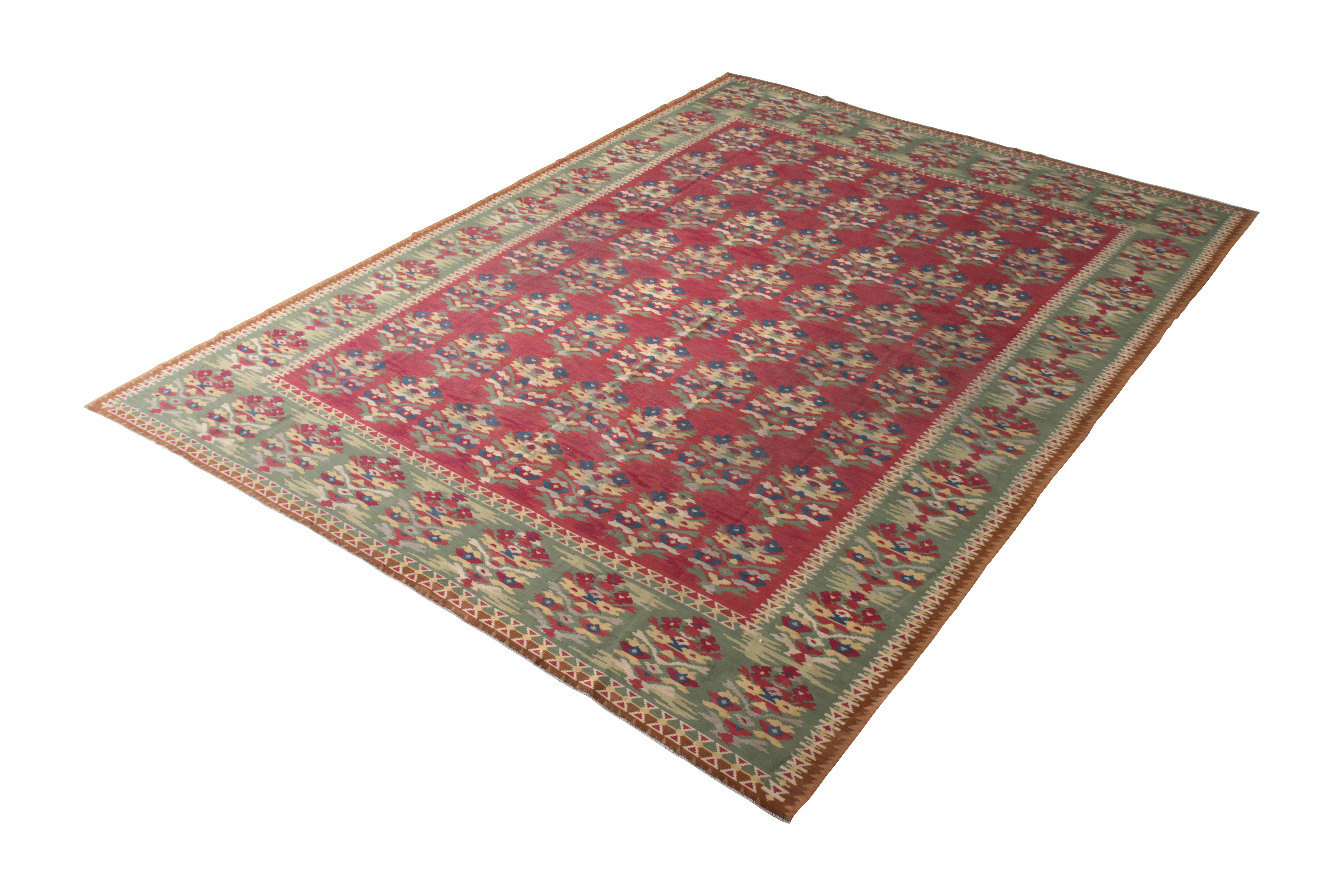 Handwoven in a wool flat-weave originating from Turkey circa 1950-1960, this vintage Kilim rug connotes a mid-century Turkish Kilim rug design in a transitional play of Classic geometry and progressive colors—a sought-after red and green playing