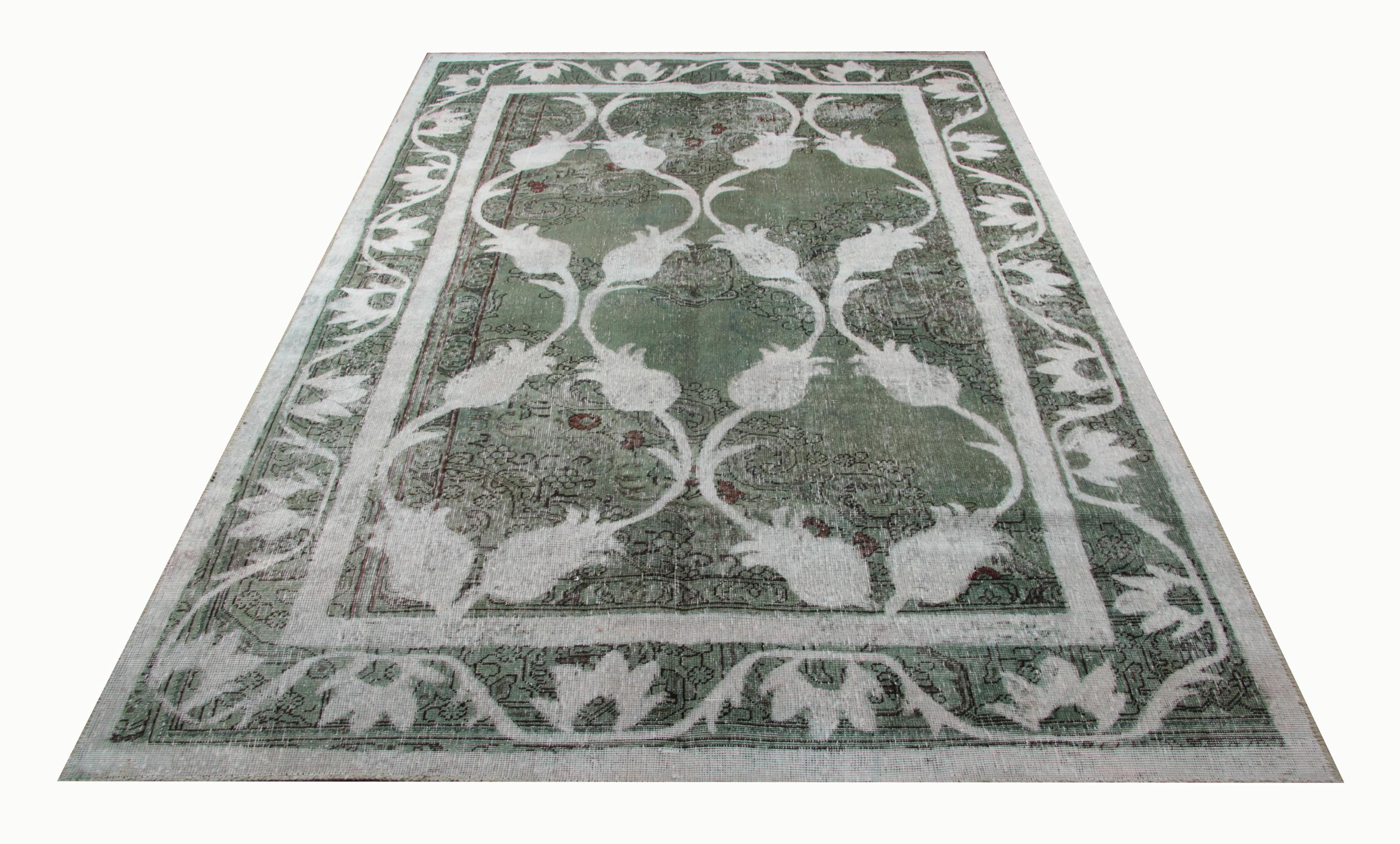 This handmade carpet oriental rug predominantly green handwoven vintage Turkish rug features a white floral pattern on a green background. This hand-painted oriental carpet is a stunning example of a handmade home decor rug. Because of its unique