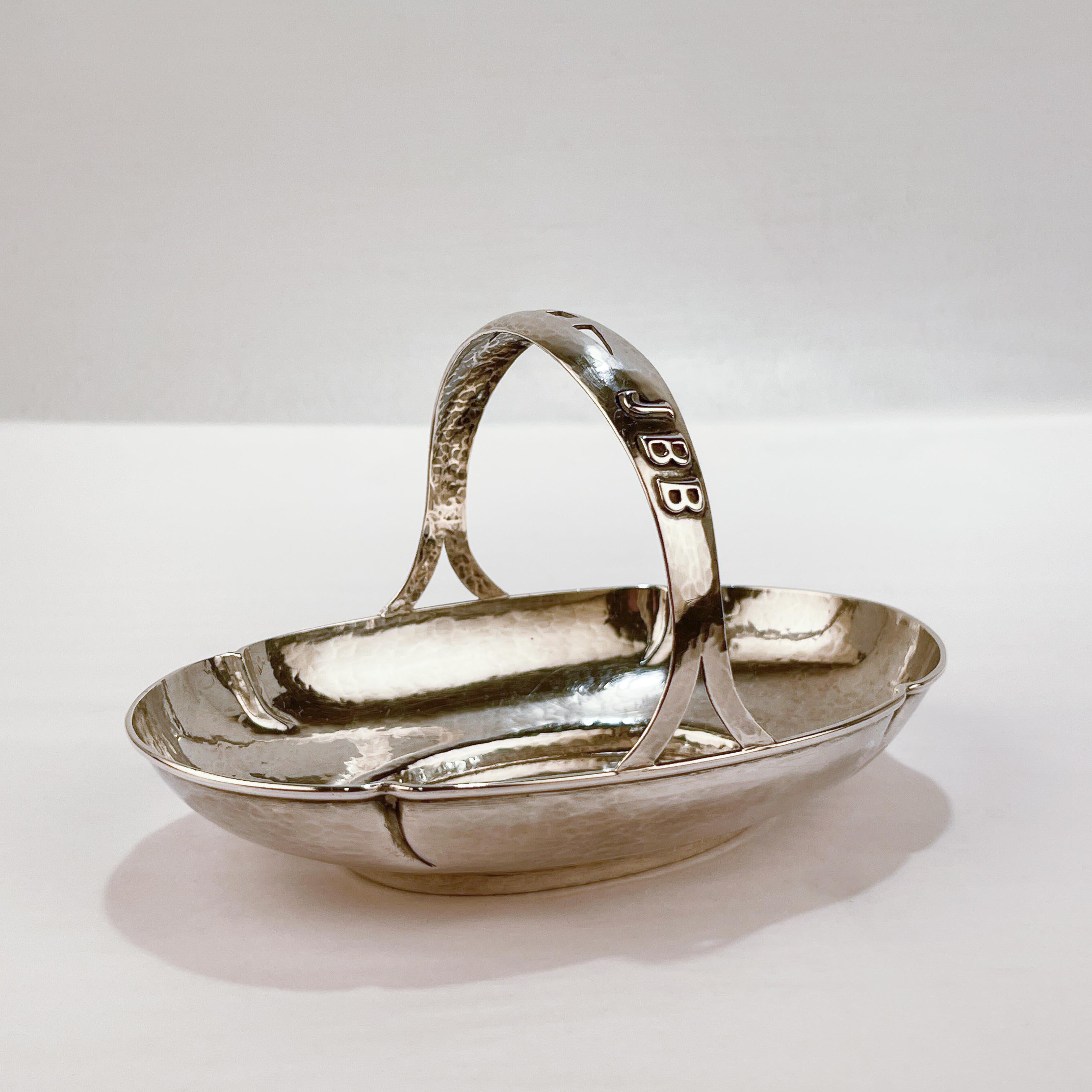 A fine hand wrought arts & crafts sterling silver basket.

With a lobed body with pierced handle and a raised 'JBB' monogram is applied to the handle.

Made by the female American silversmith Anna Eicher who was active in Parkridge, Illinois