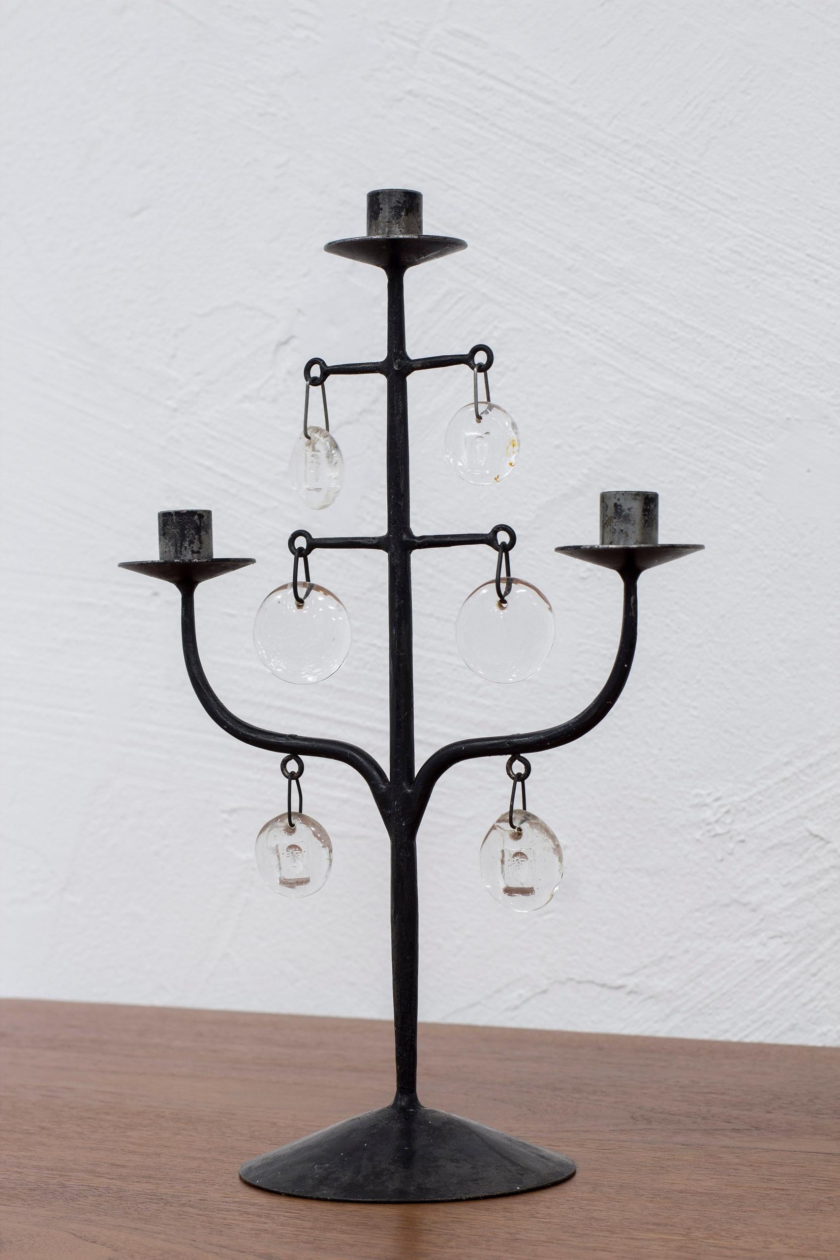Candelabra designed by Erik Höglund. Made by hand in iron at Boda smide and clear glass prisms from Boda glass. Three arms and six glass shards. Very good vintage condition with light age related patina from use and wear. With original