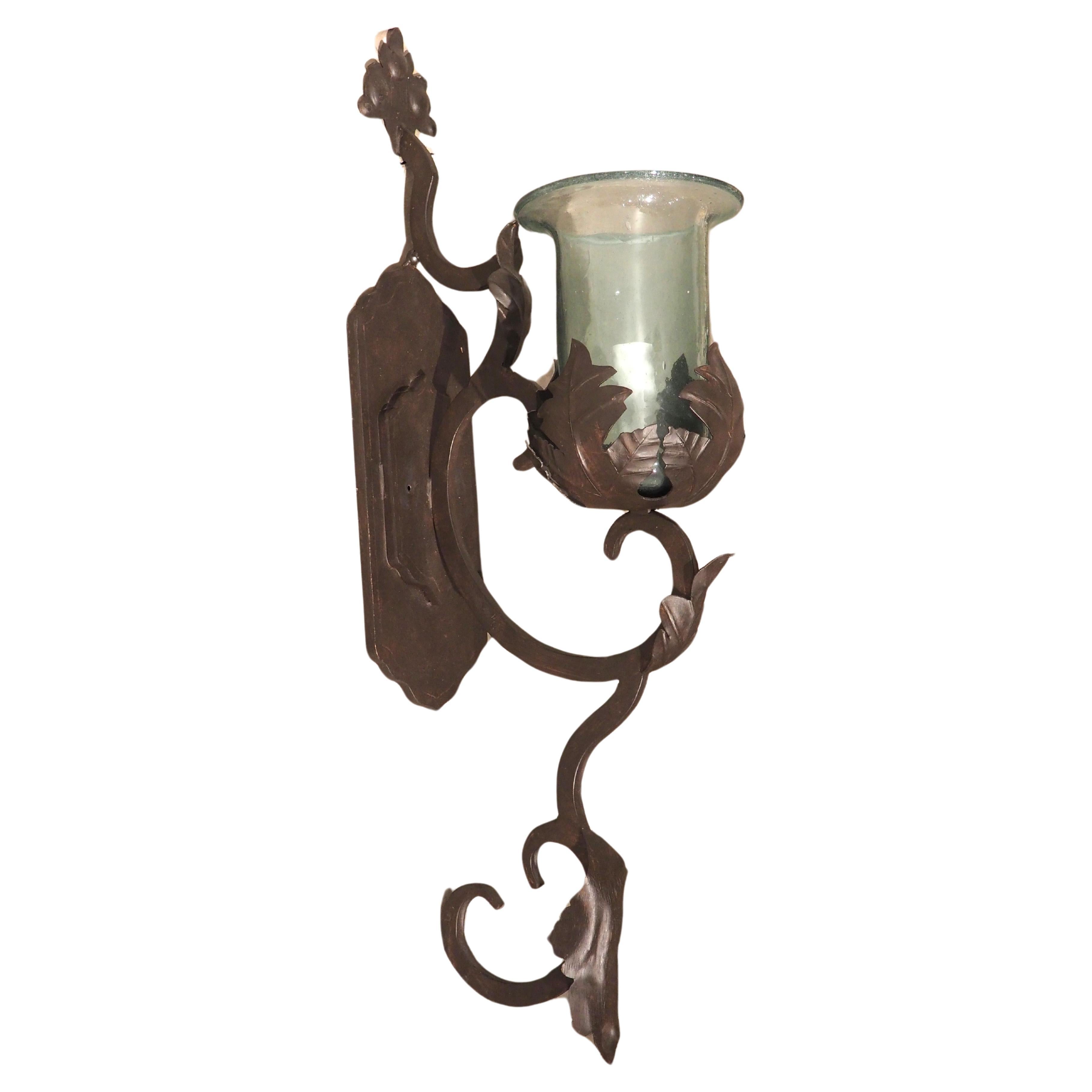 Hand Wrought Iron and Glass Wall Sconce with Foliate Motifs For Sale