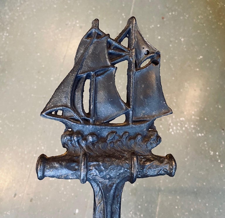 Antique hand wrought iron ship and anchor Andirons, circa 1910, hand hammered and embossed schooner above anchor, mounted on an arched base with pad feet. A classic New England andiron that has consistently been the most popular style we have ever
