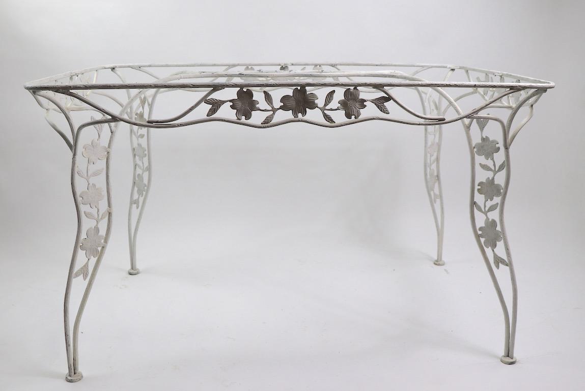 Extraordinary handwrought dining table with original plate glass top. The wrought frame is finished with a bark surface, adding to the attention to detail shown in this fine example. Originally designed for outdoor or patio use, also suitable for